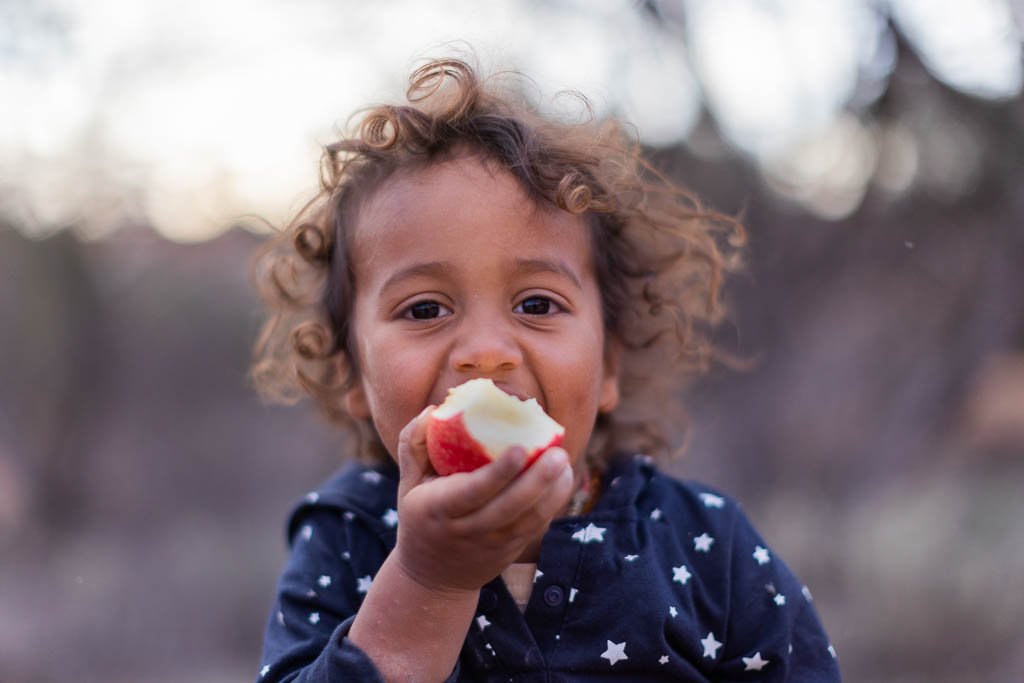 Small child eating an apple