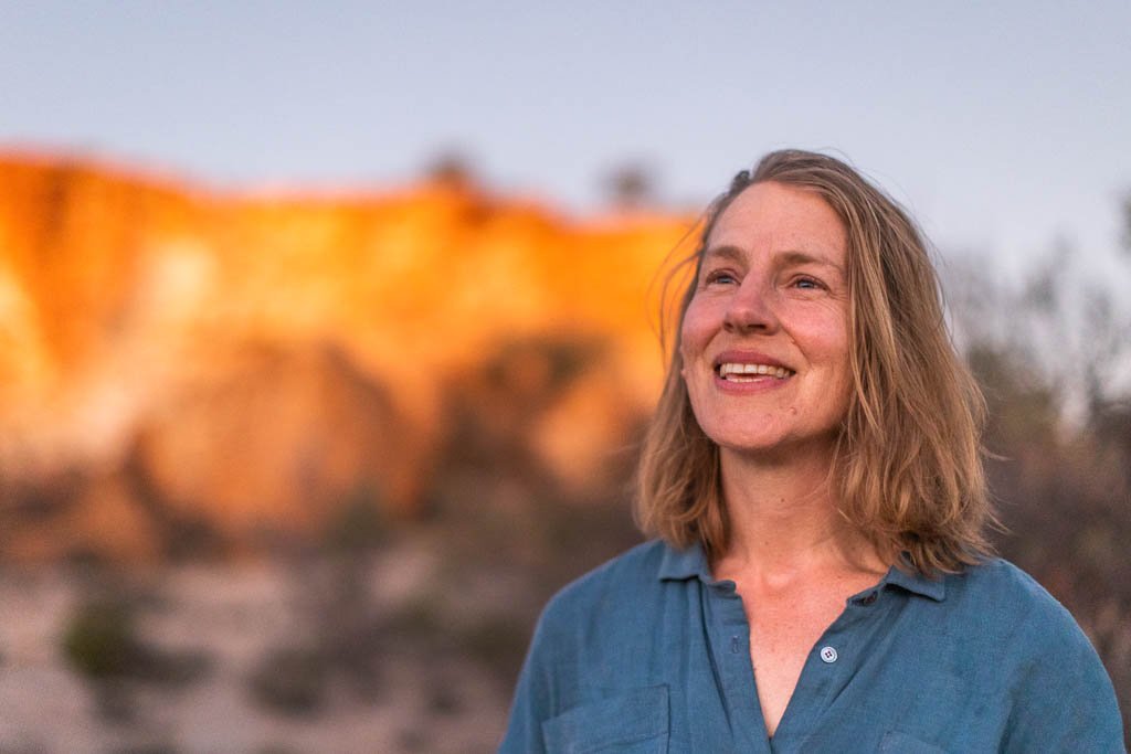 Artist Lucy Ridsdale at sunset on the Reclaim the Void camp in the WA Goldfields