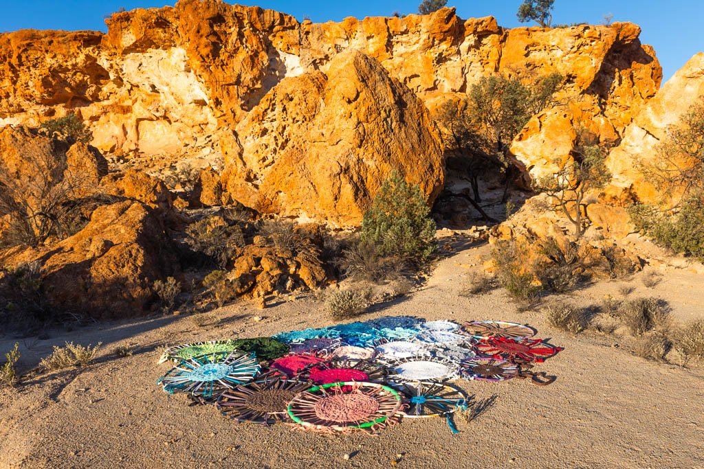 A selection of the rugs woven for Reclaim The Void on display amongst the breakaways in the Northern Goldfields of WA