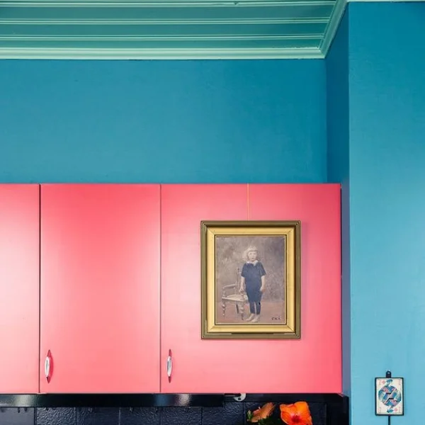 Ingenious hanging of art by hooking over a cupboard door via JennyOJens