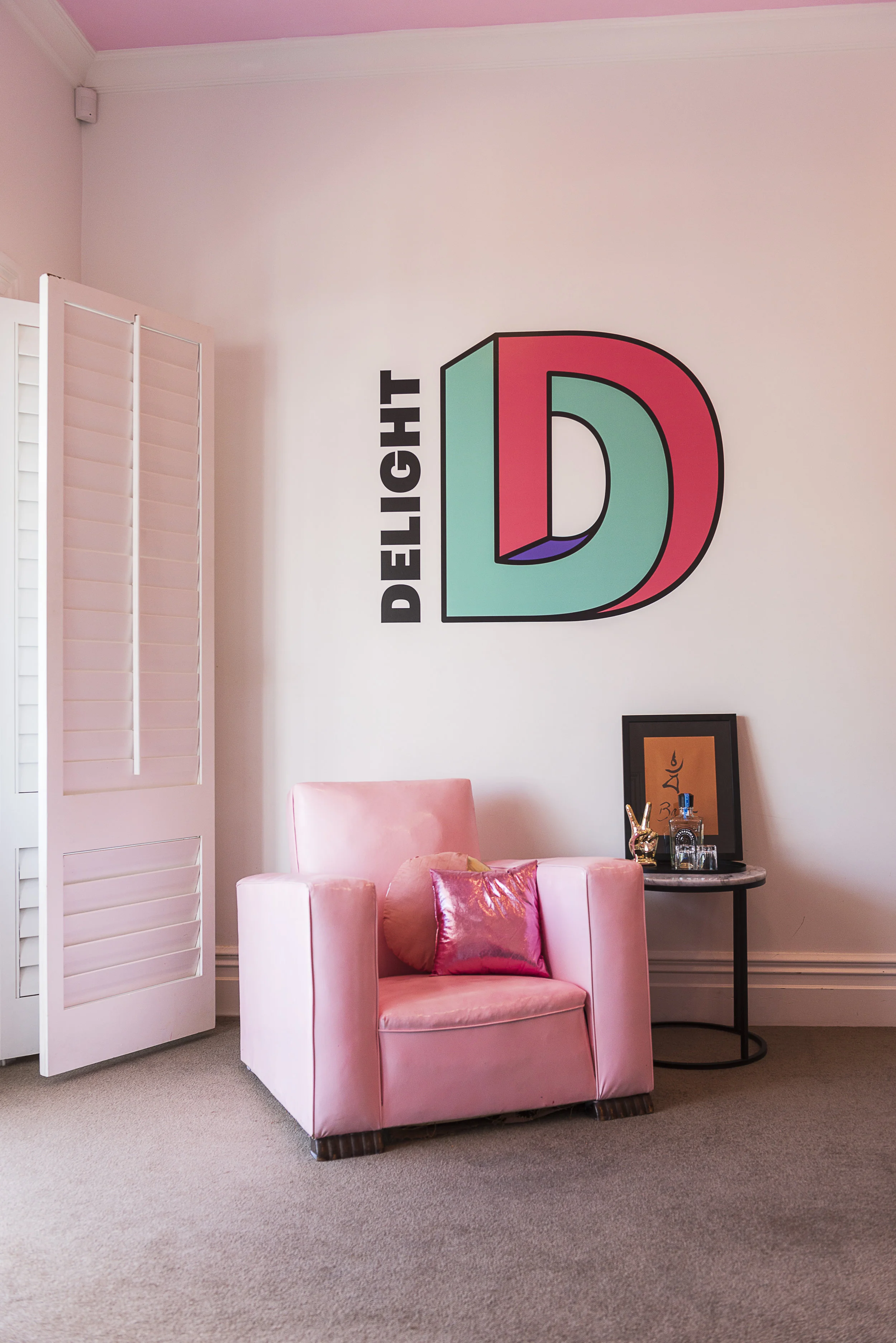 Delight’s new logo provided the colour inspiration and made a fun wall decal in the main office above a custom painted Art Deco arm chair. Photograph by Helen Bankers