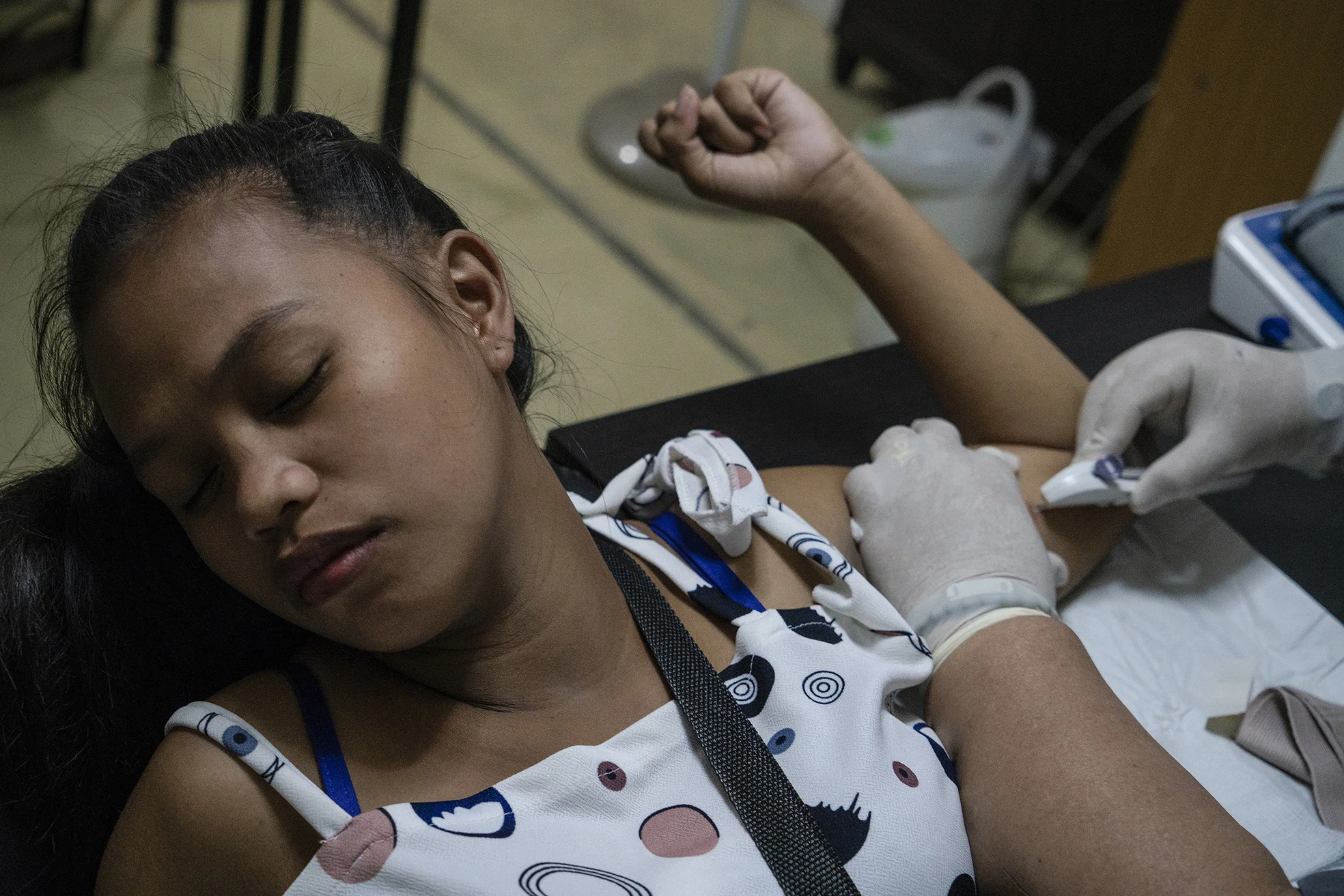 Judy May Aguilar, 19, gets an implant from Likhaan clinic in Tondo, Manila on October 22, 2018. Aguilar was 17 years old when she first gave birth to a boy and had another child since then. She traveled for four hours from her home in San Jose Del Monte Bulacan to avail the free service from Likhaan.