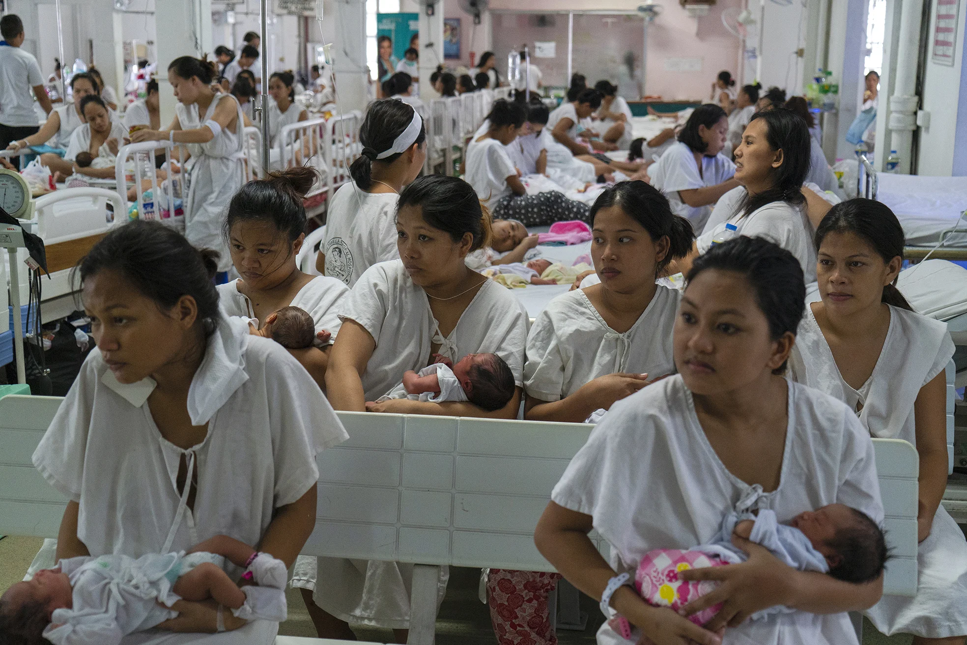 Newly given birth patients line for a checkup inside a ward in Fabella Hospital in Manila on October 21, 2018. Dr. Jose Fabella Memorial Hospital is considered the busiest maternity hospital with an average of 60 births a day from the poorest patients in Manila and nearby provinces.