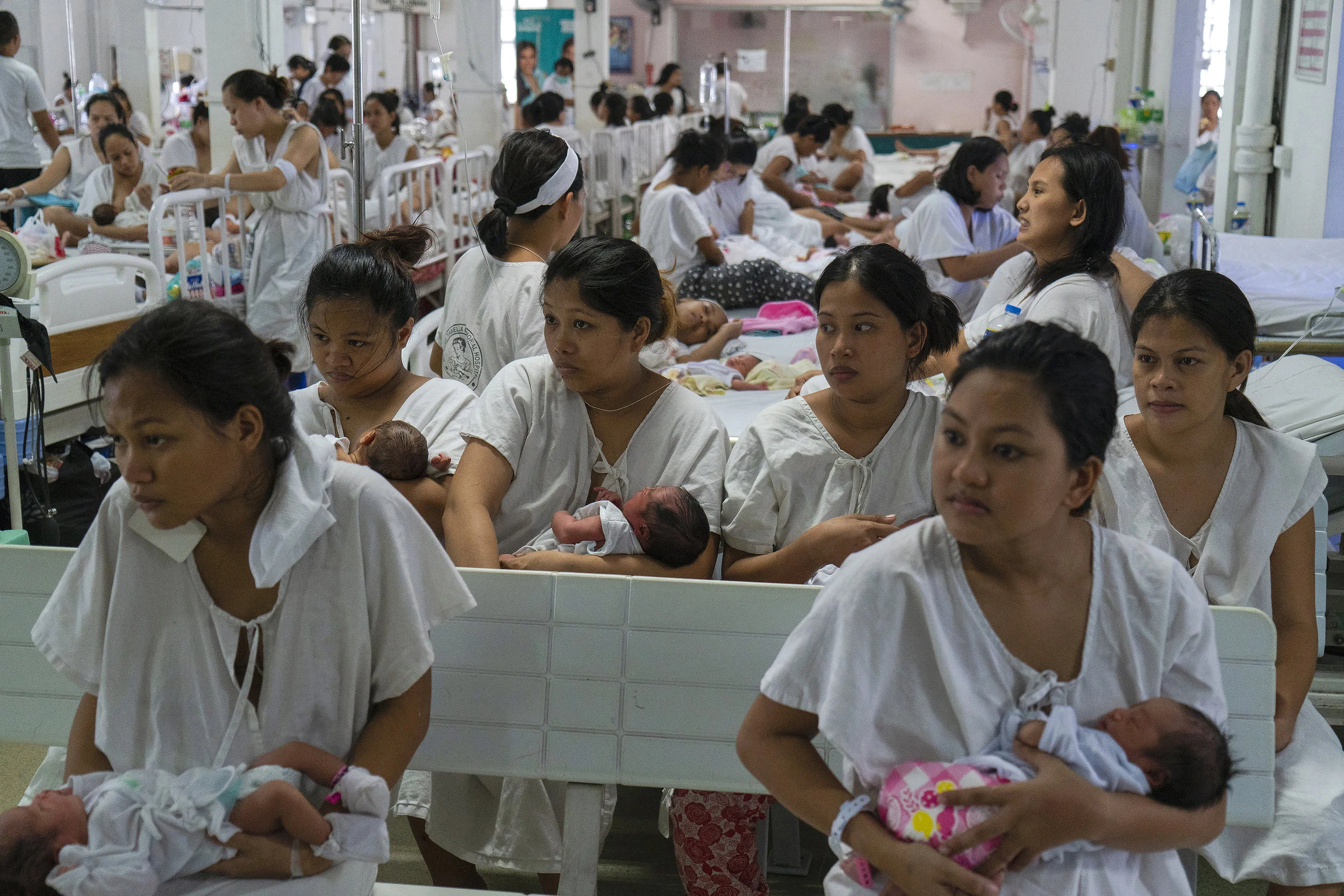 Newly given birth patients line for a checkup inside a ward in Fabella Hospital in Manila on October 21, 2018. Dr. Jose Fabella Memorial Hospital is considered the busiest maternity hospital with an average of 60 births a day from the poorest patients in Manila and nearby provinces.
