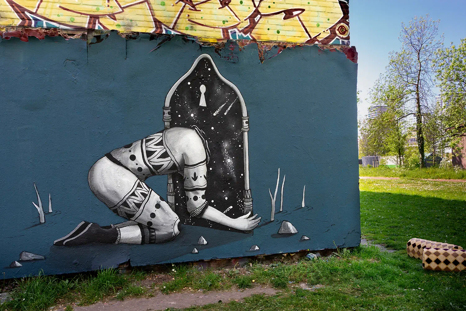 Surreal cosmic portal mural painted in Amsterdam by contemporary street artist Skount exploring transformation and infinite possibilities.