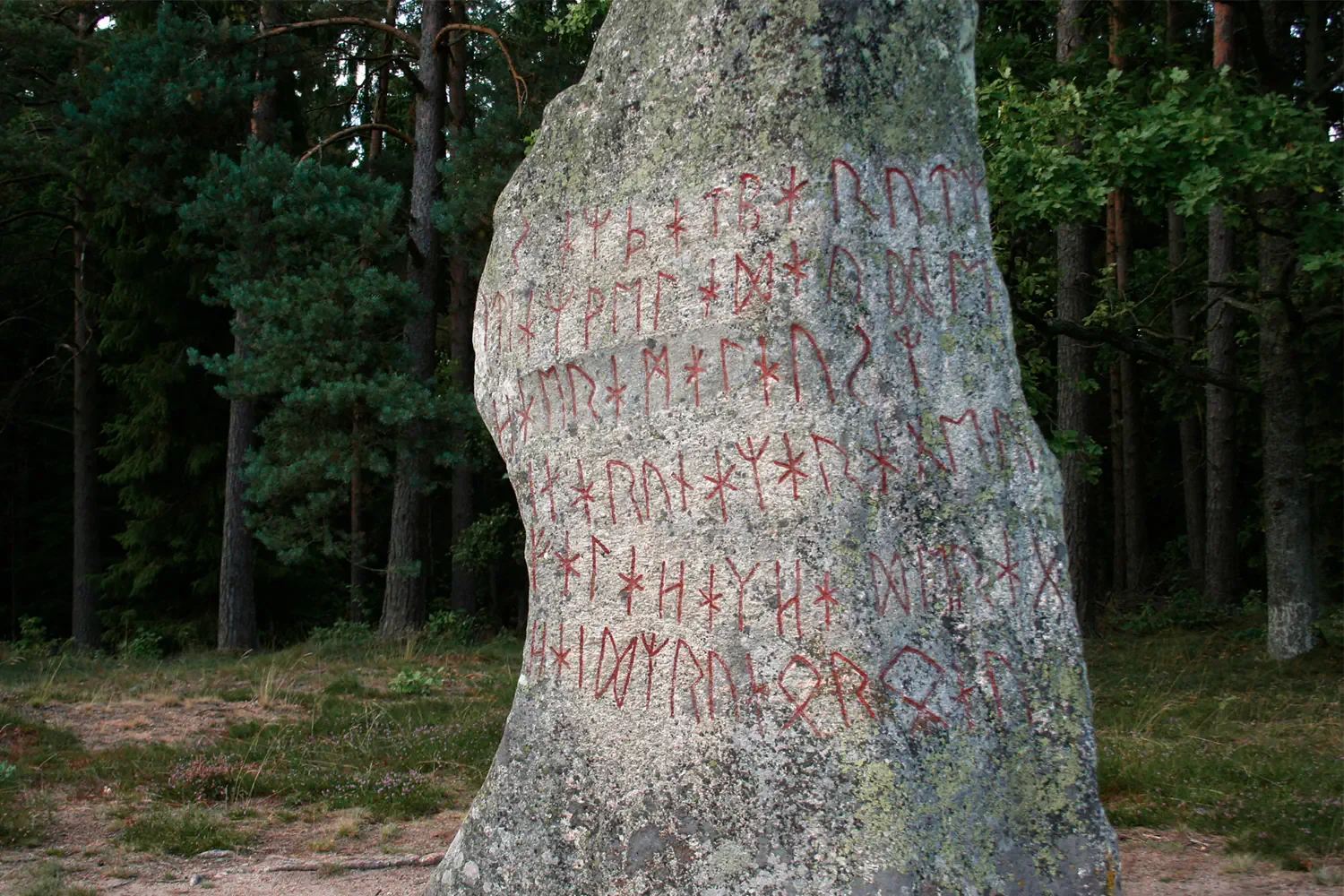 Painted Viking rune symbols on a carved stone surface