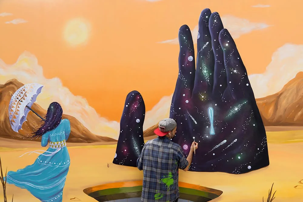 Skount painting a symbolic and surreal artwork in his studio, exploring identity, masks, and personal transformation.