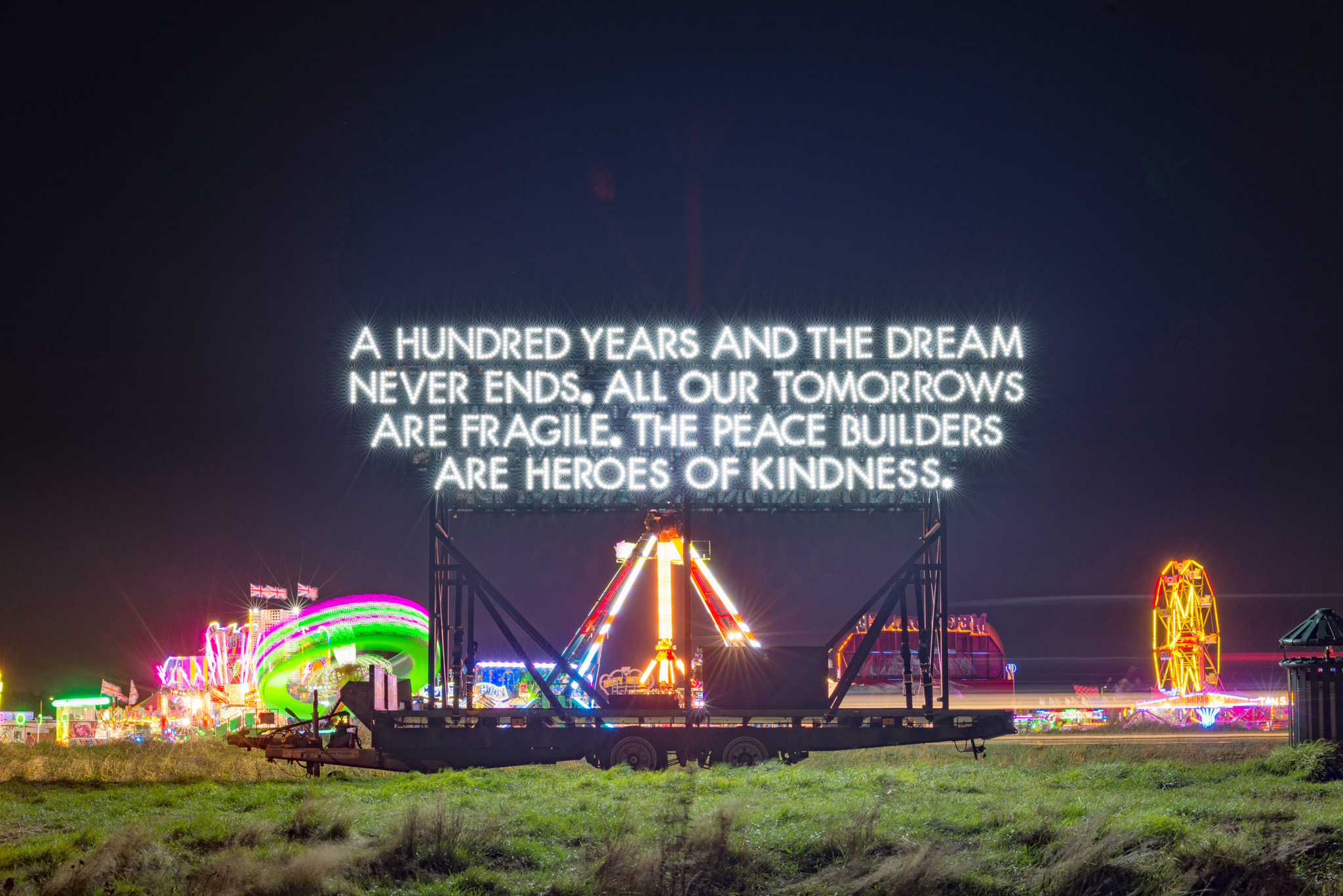 Emergency Exit Arts. A 14ft high illuminated mobile artwork, 'Peace Poem' by Emergency Exit Arts and poet and artist Robert Montgomery.