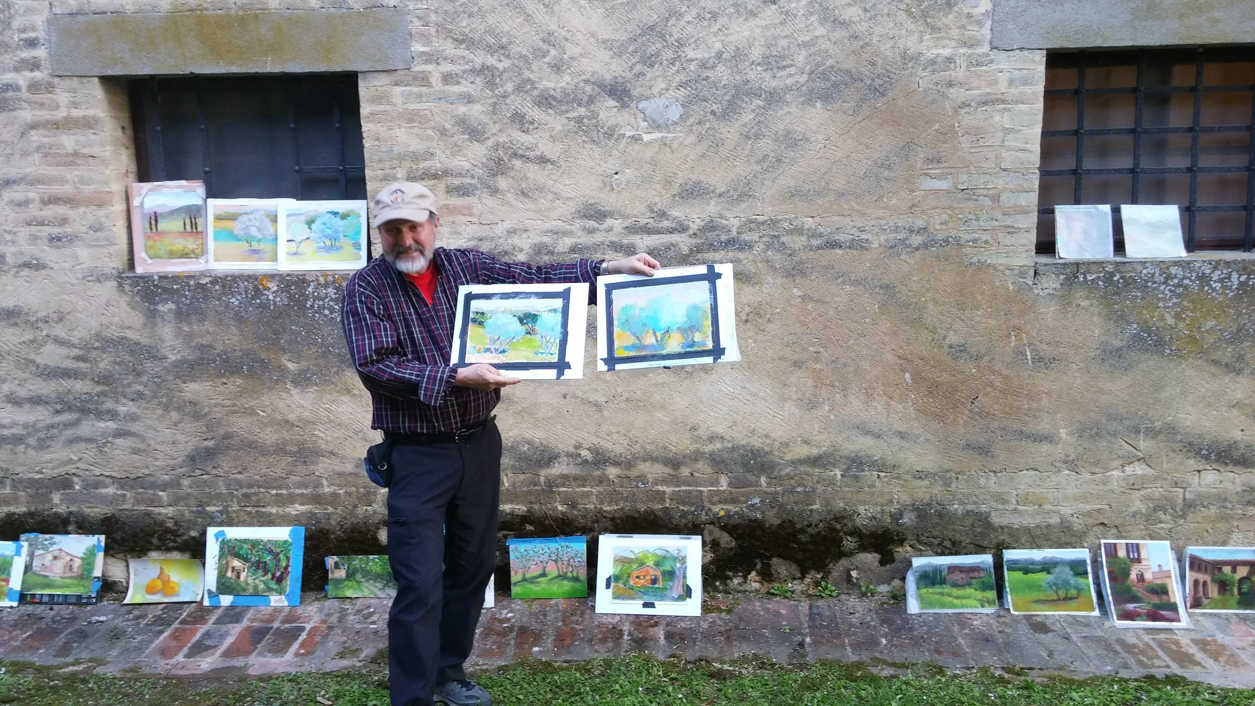 Well known pastel instructor Robert Carston offers critiques at end of a week's work in Tuscany.