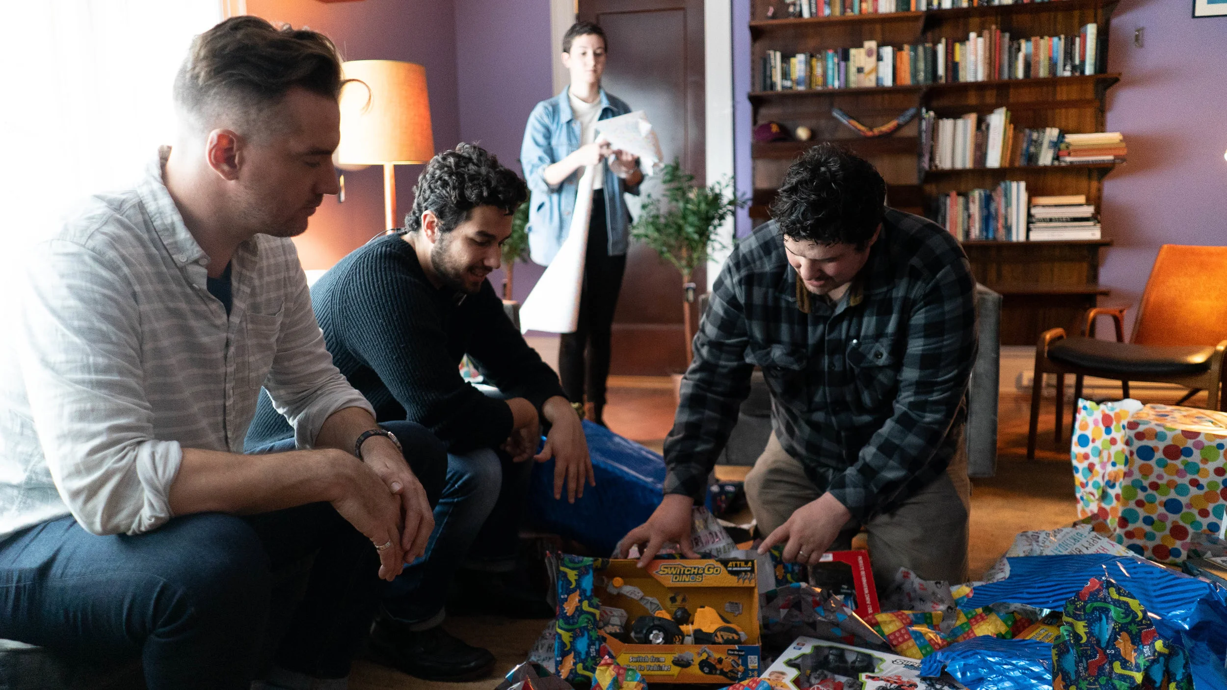 (Left to right): Director Kess, Producer Kyle, and Production Designer Ian, discuss the placement of props on set.