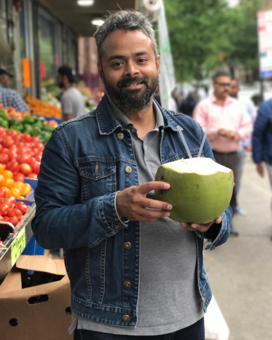 Dhrubo with our coconut-for-two, hacked before our eyes on 37th Avenue.