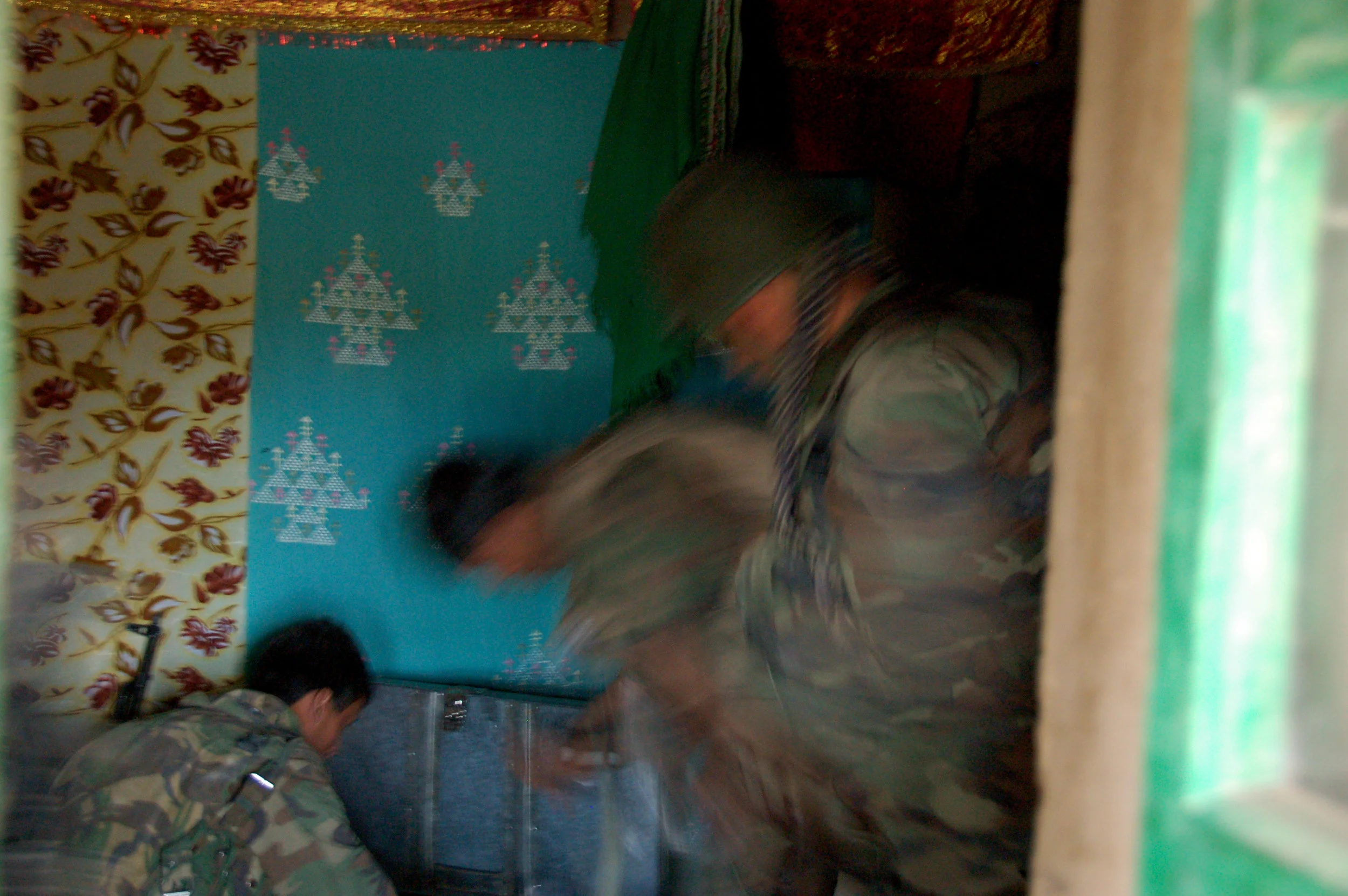 Afghan soldiers search a house in the Balochi Valley, Uruzgan province. November 2007.