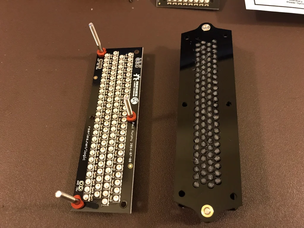 Next up, attaching the PCBs to the assembled bezels. The rubber washers are only mentioned in the instructions for the large logic. An edge was trimmed from each one, so as not to occlude the nearby LED.