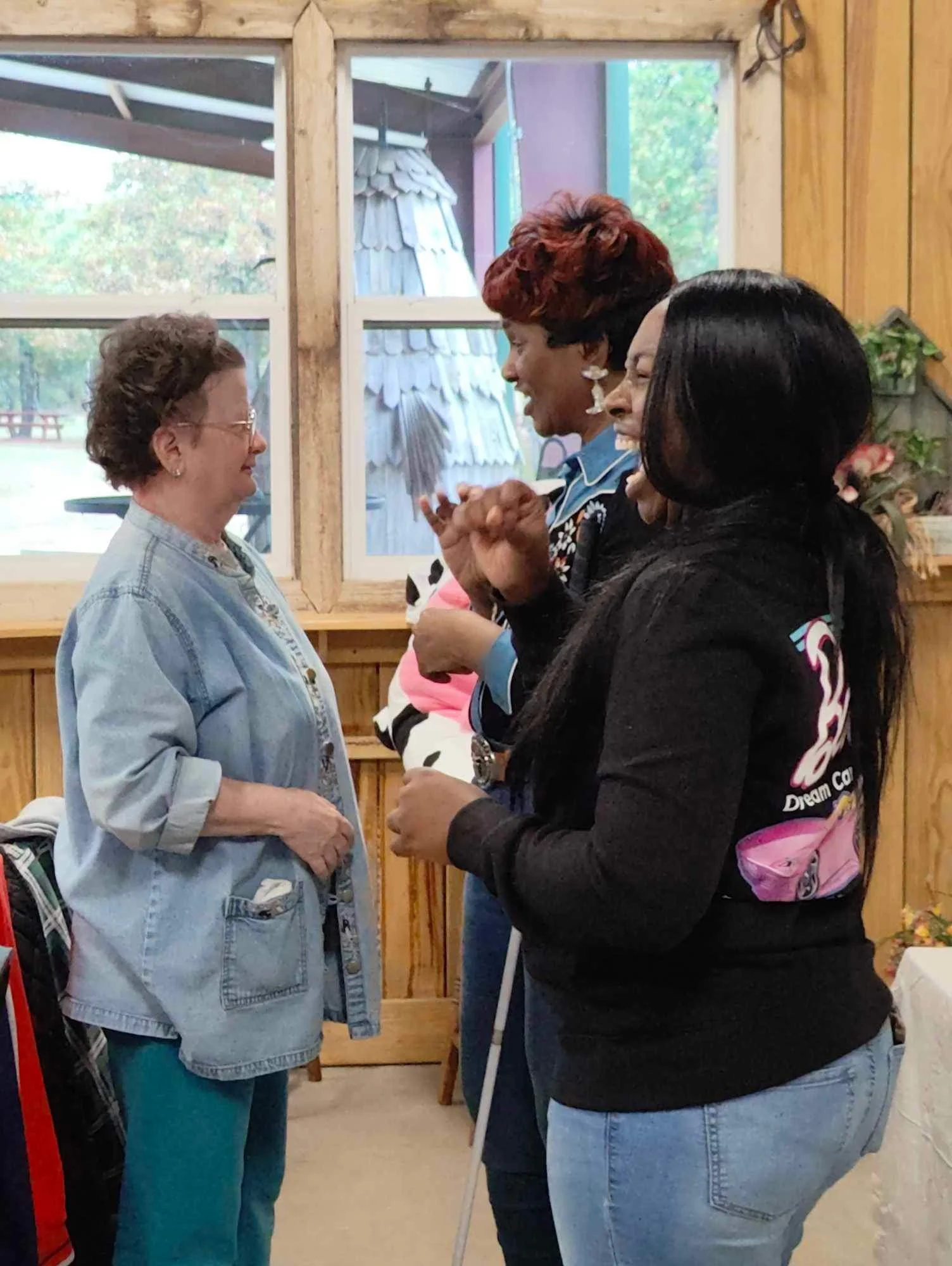  Two woman are talking and an SSP is accompaning Cassandra (left) in her jean cow girl outfit 