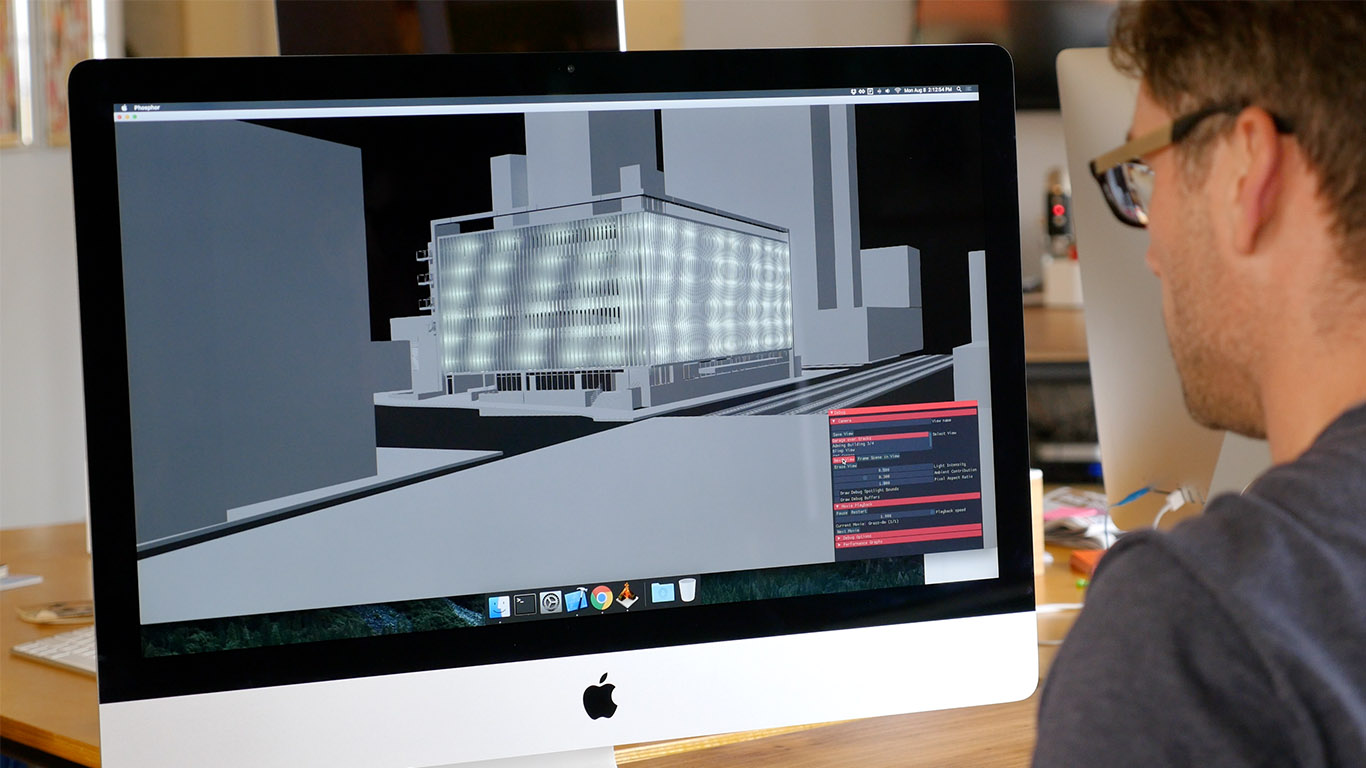 Justin Manor controls software to view what a seagrass animation would look like on a virtual model of the building.