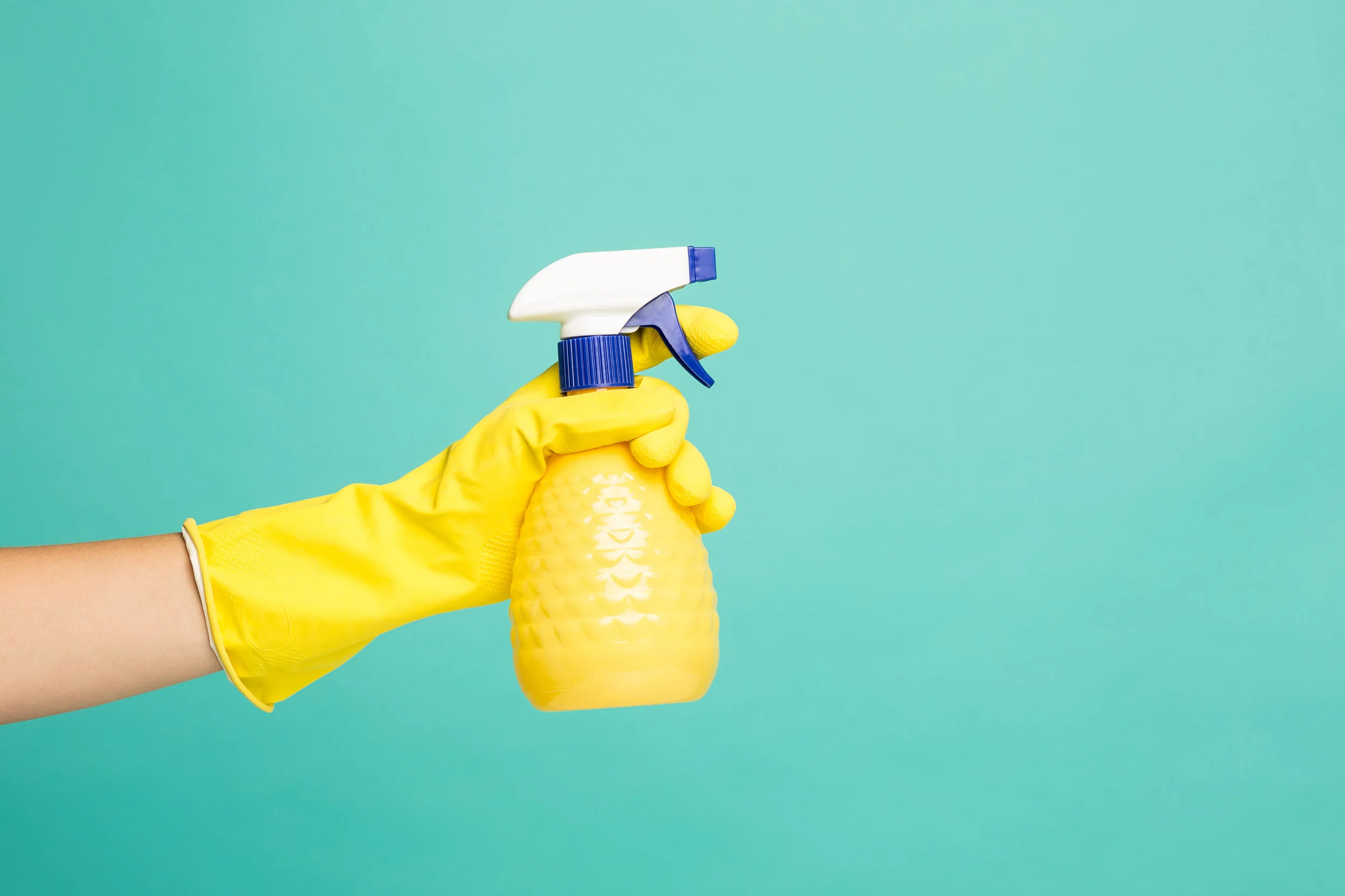 Yellow Spray Bottle on Blue Background.jpg