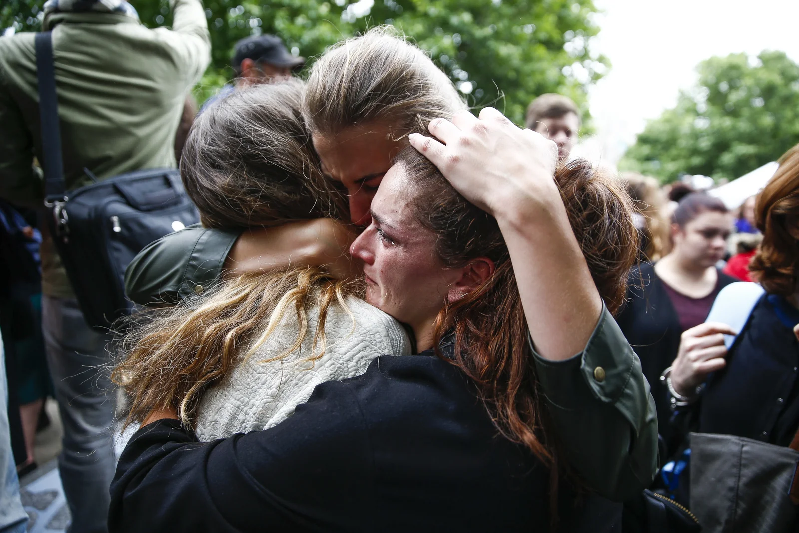 People embrace following a vigil in London to remember those killed in the London Bridge terror attacks.