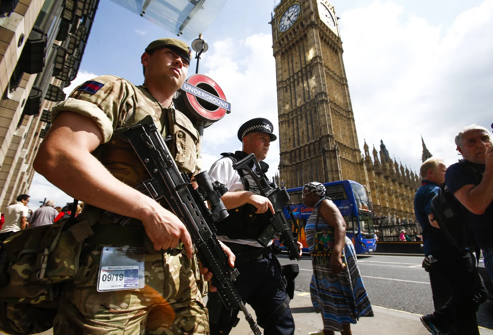 A British soldier joins police on guard outside the Houses of Parliament, London.