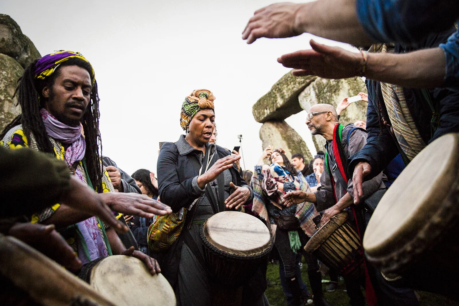 People sing and dance as the sun rises at Stonehenge in Wiltshire on the morning of the summer solstice.