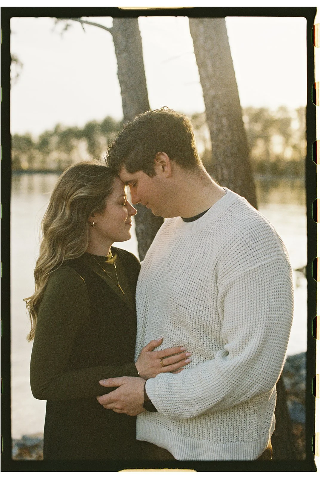 a couple with their foreheads together at smith mountain lake virginia