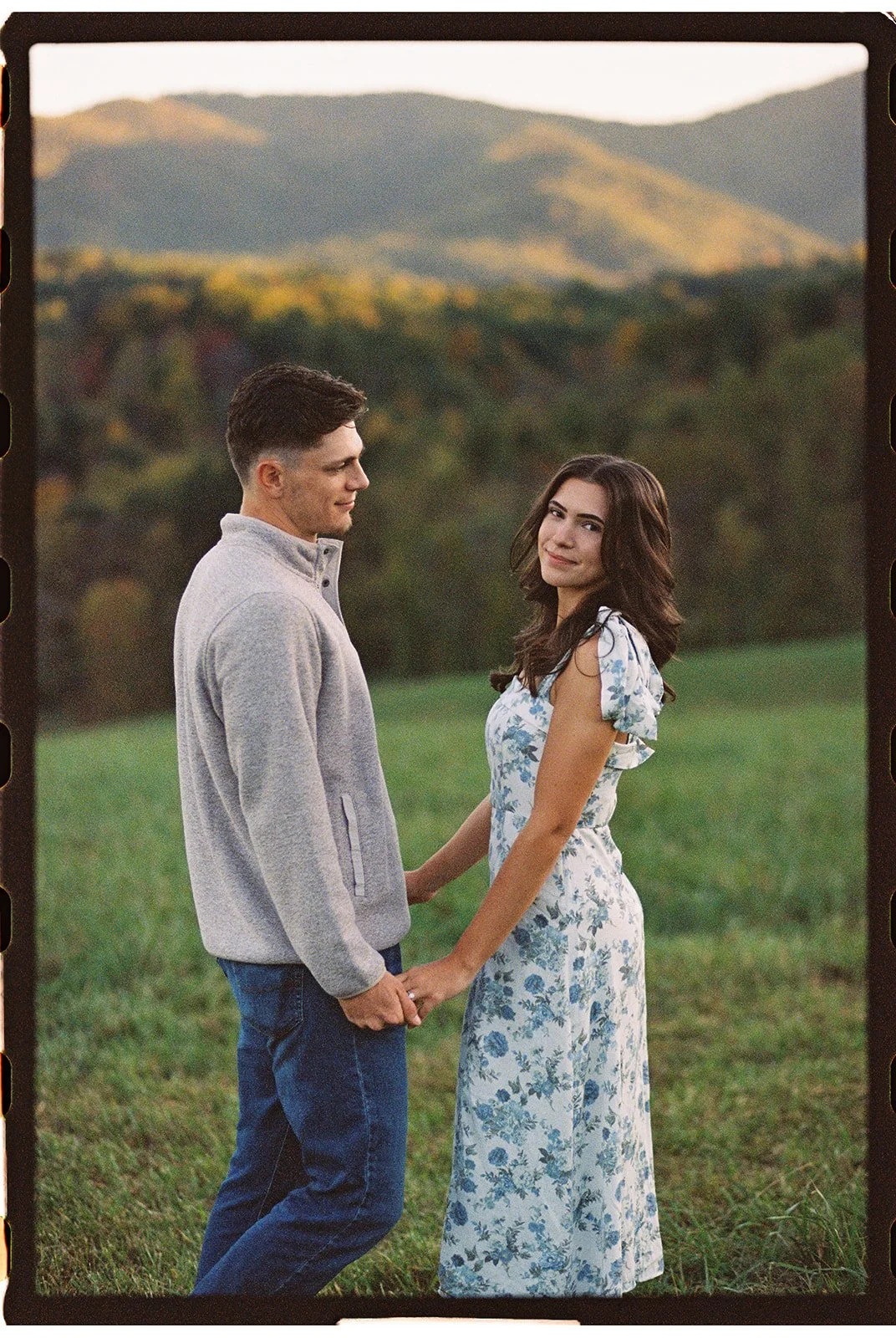 a couple holding hands and the woman looking at the camera at green hill park in salem virginia