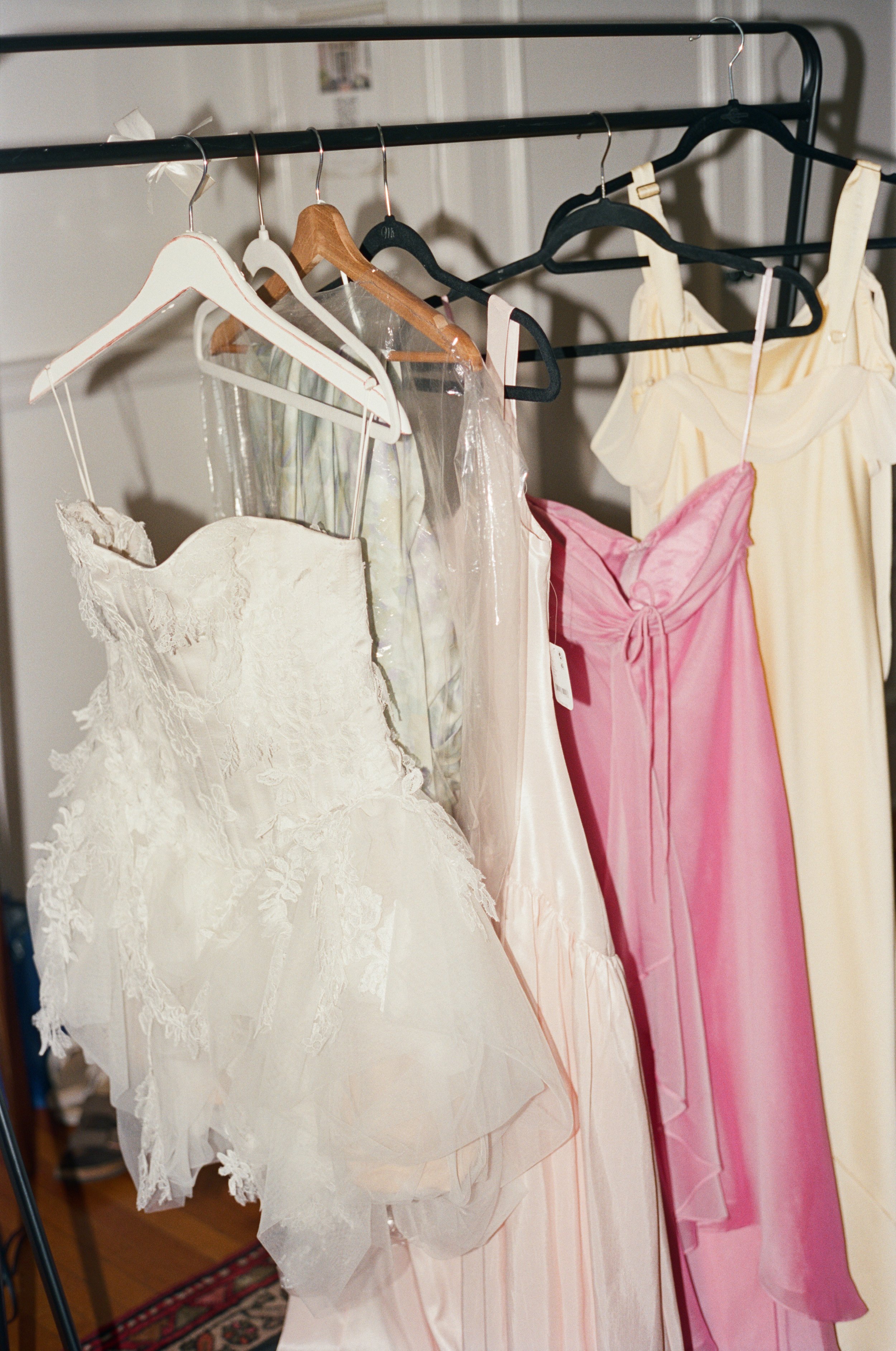 Wedding dresses and gowns hanging on a clothing rack in an airbnb in Richmond Virginia.