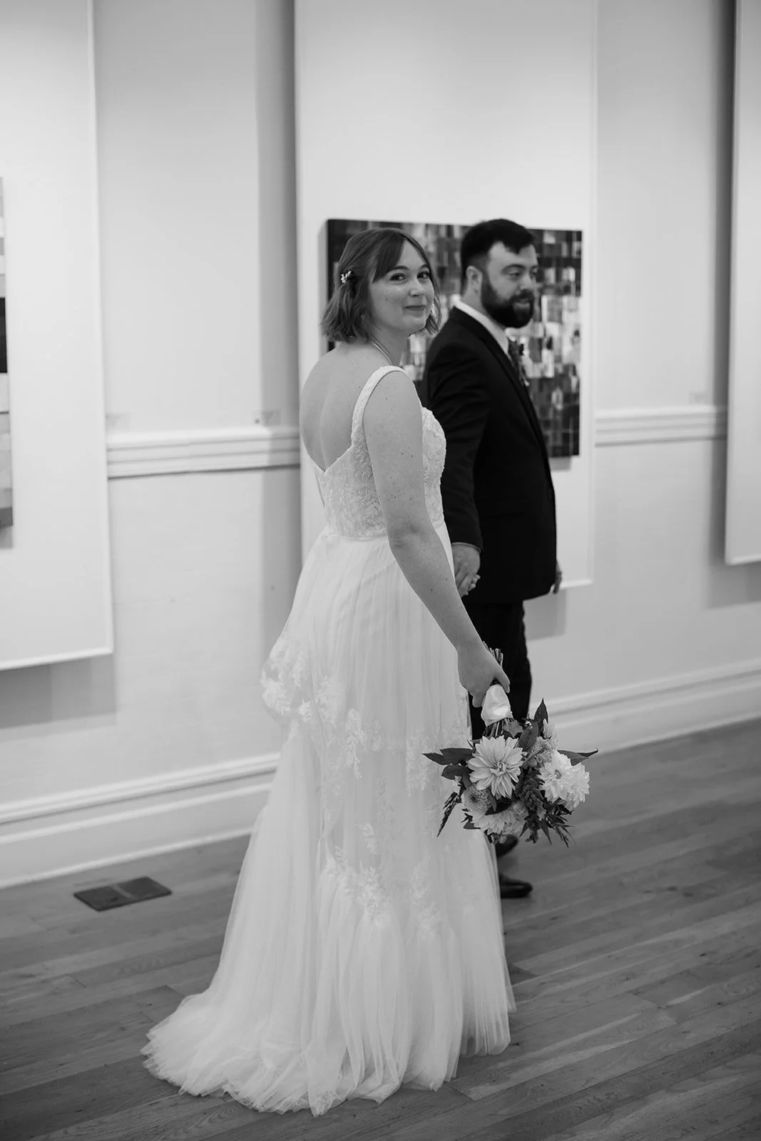 black and white photo of a couple walking inside the art museum in Staunton Virginia