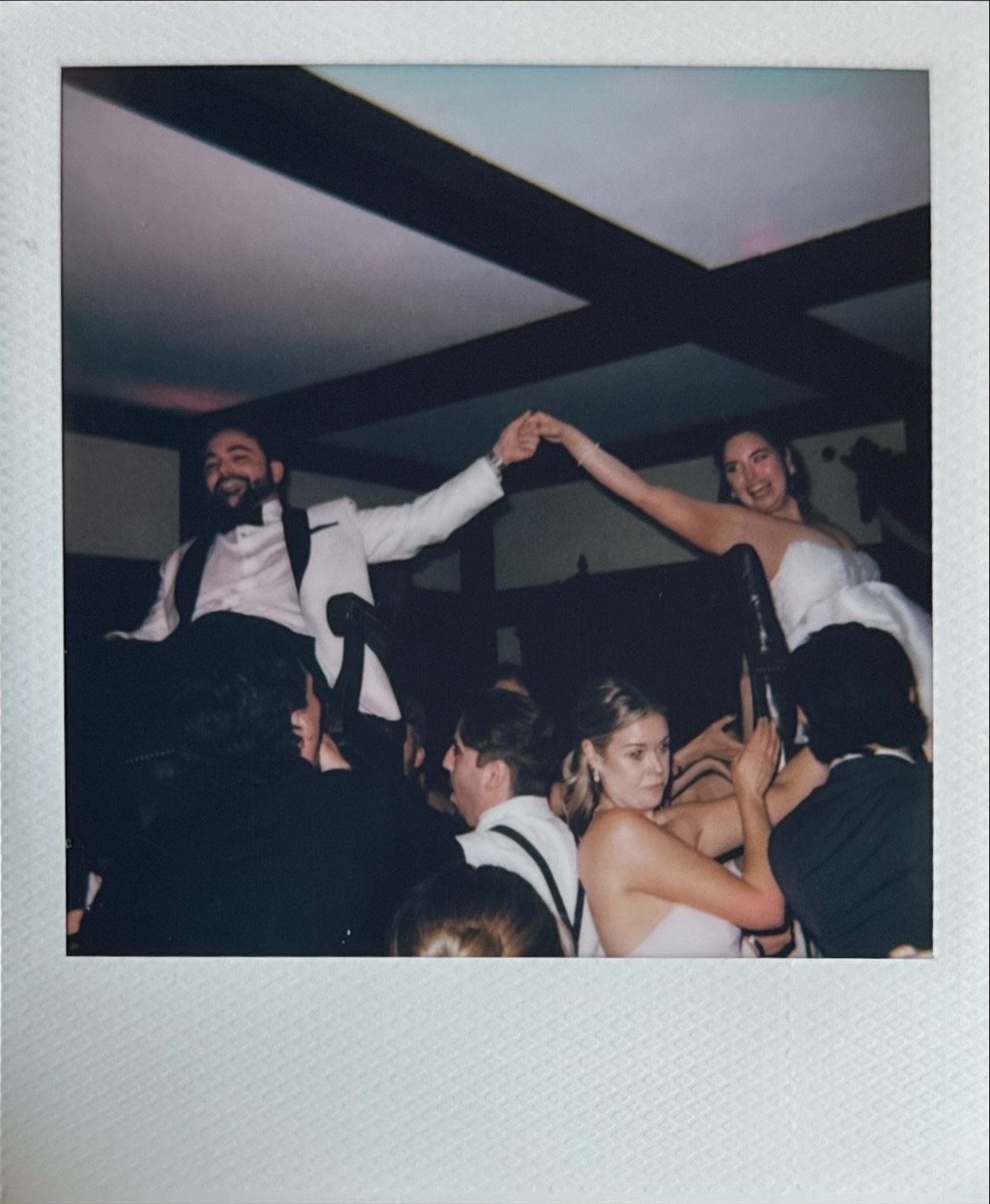 A bride and groom dancing at their wedding reception with guests surrounding them. Gramercy Mansion Wedding Maryland Film Photographer Polaroid
