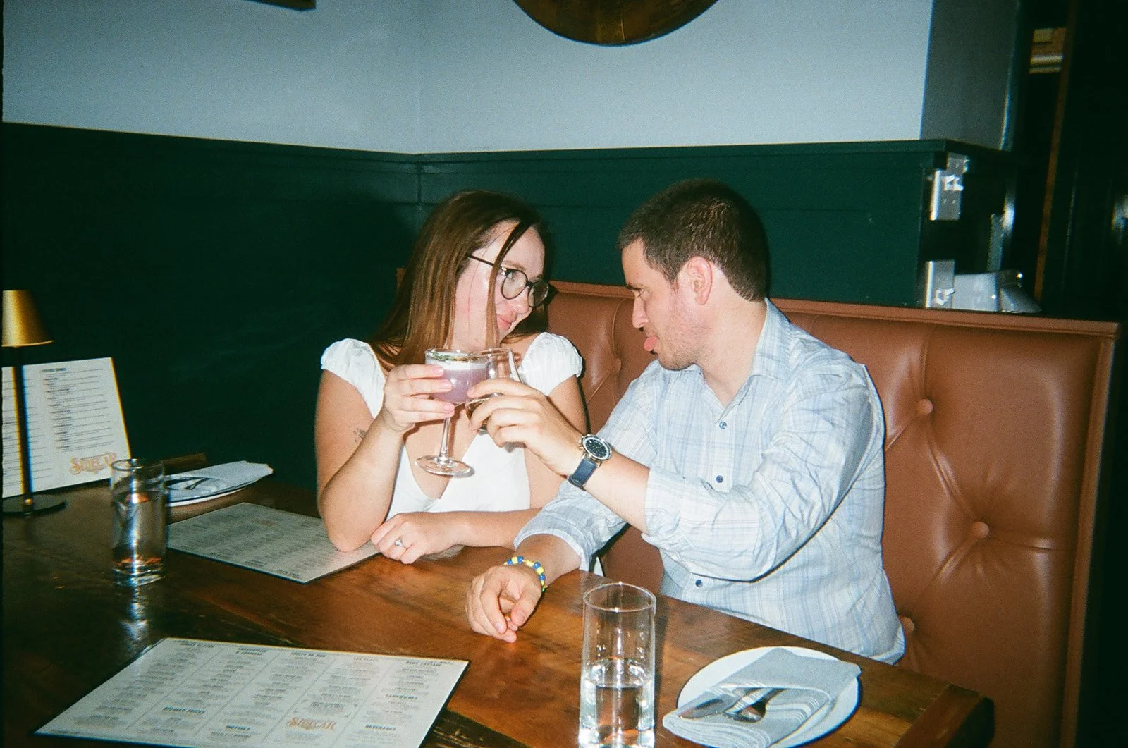 couple cheersing drinks at sidecar in downtown roanoke virginia