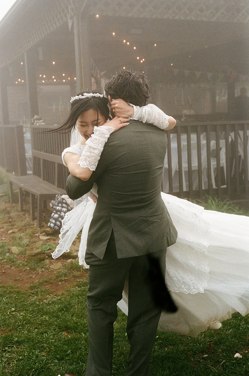 A groom lifting a bride in a romantic dance outdoors during wedding celebration. Floyd Virginia Wedding Film Photographer