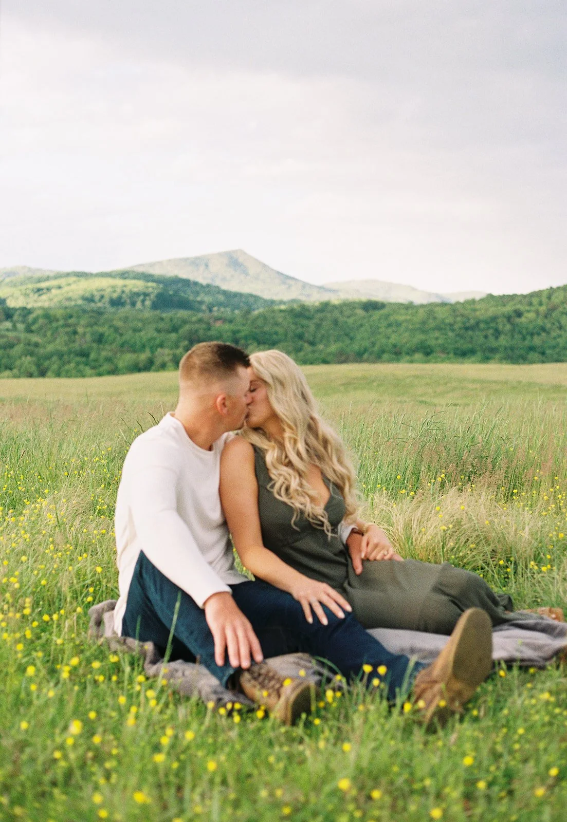 a couple kissing in the grass at back creek valley overlook roanoke va