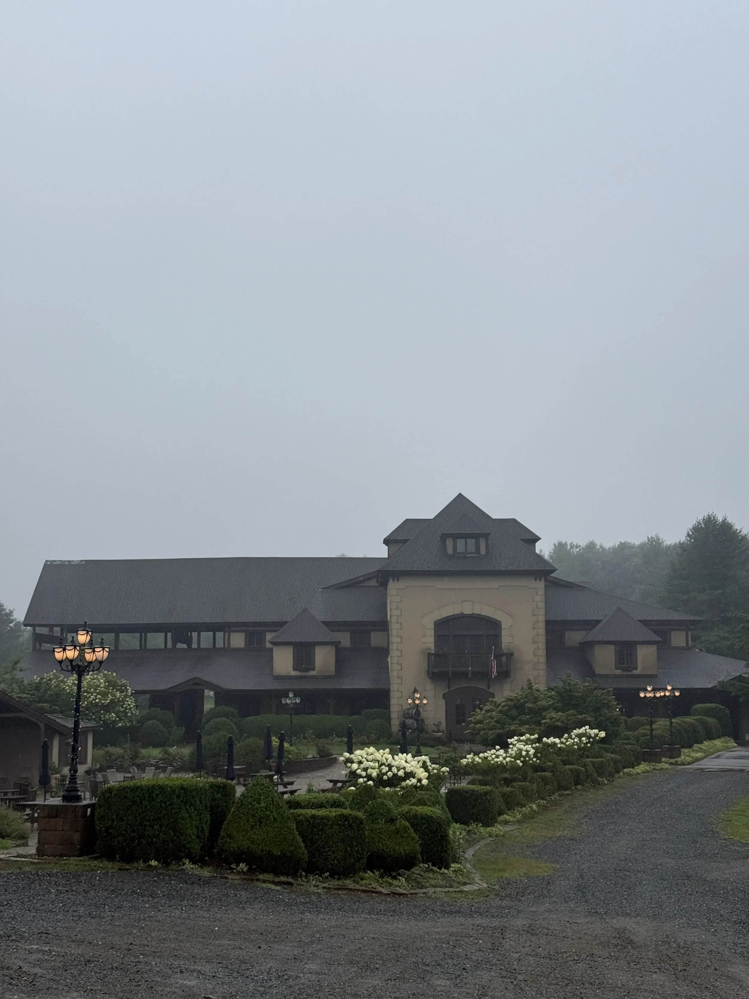 a big tan building with gardens in front of it