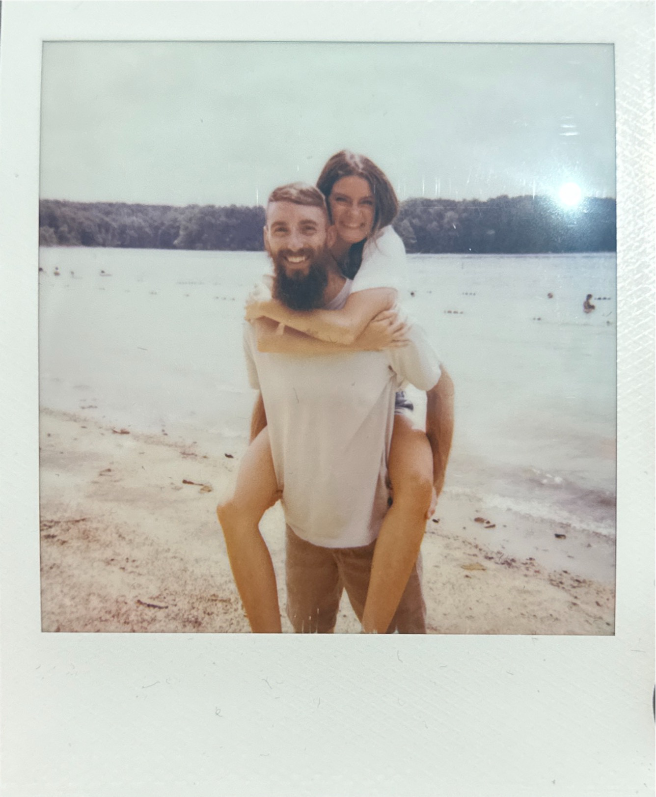 a polaroid of a couple smiling at the camera