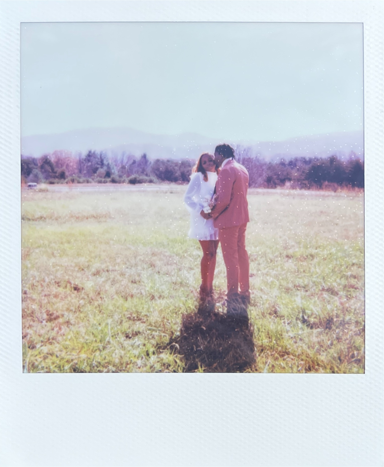 a polaroid of a couple hugging at back creek valley overlook in roanoke virginia