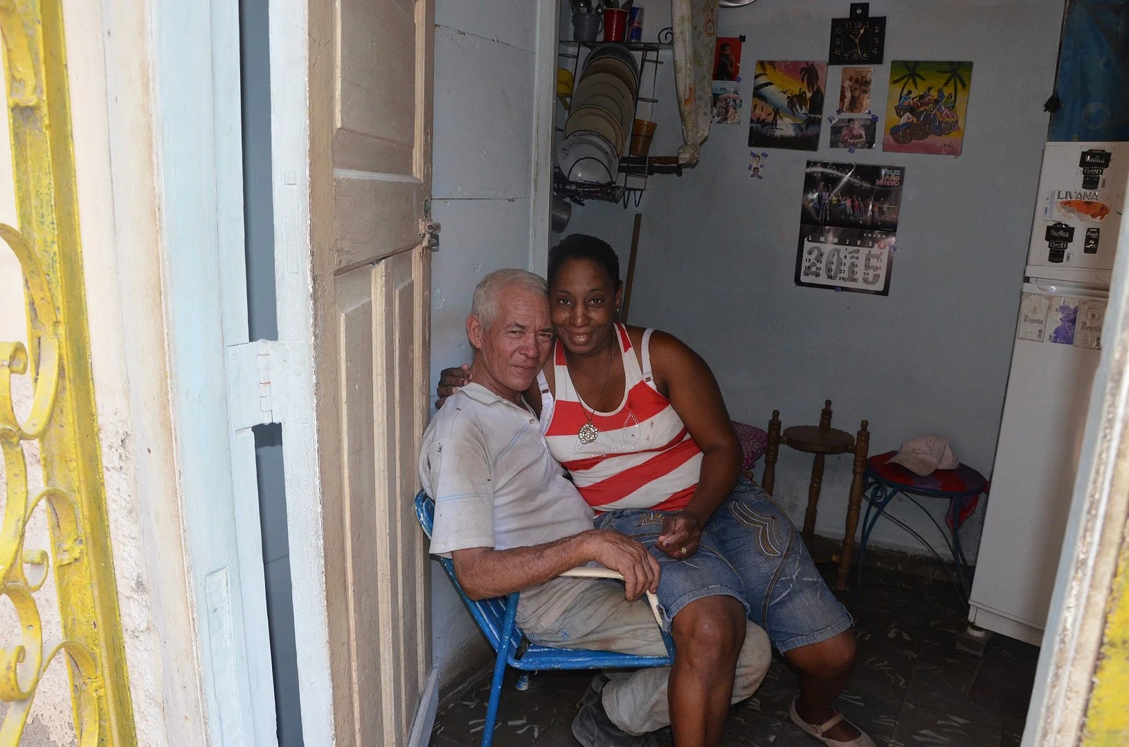   Havana Couple Sitting in the front door of their apartment   