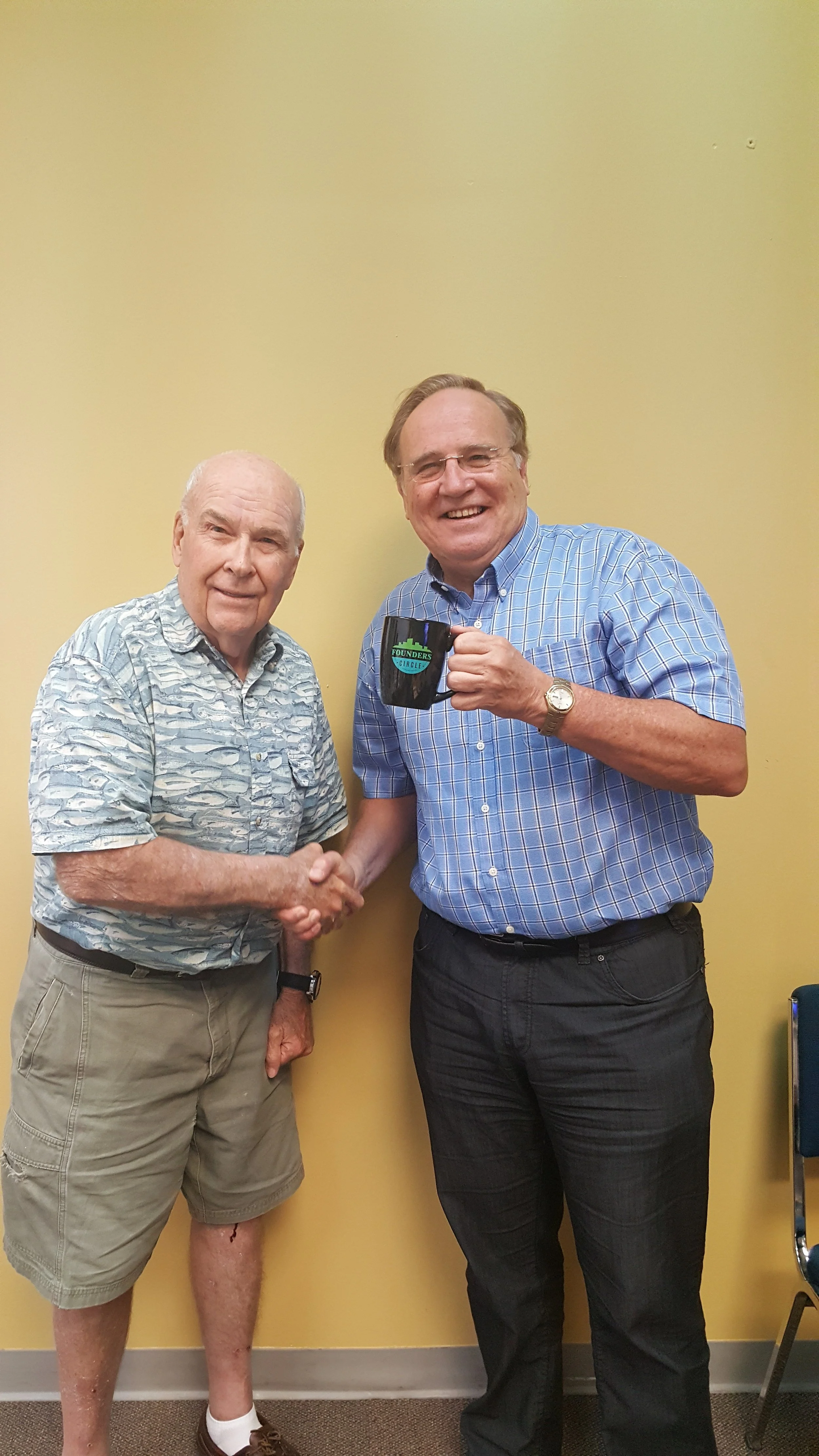 Stuart Morley presenting the Founders Circle mug to John Cooper