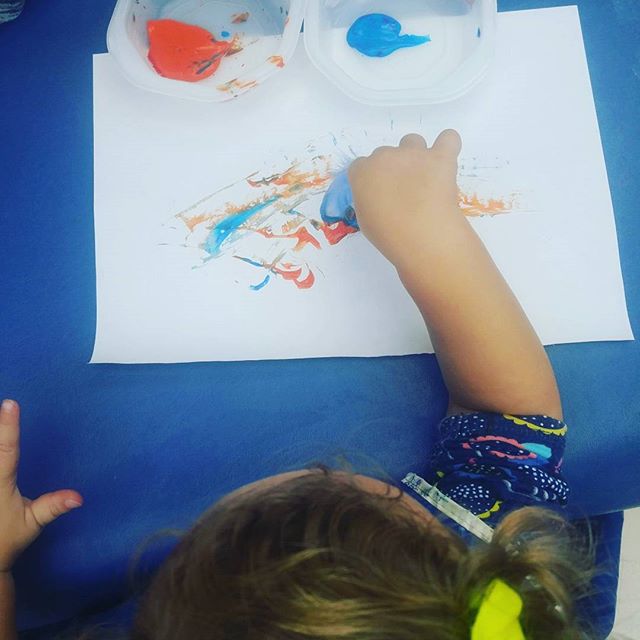 One of my favorite projects is not-paintbrushes! It's where you paint with a tool that isn't normally a paintbrush. Here you see a super sweet toddler using a feather to add paint to the page. #bbla #toddler #babiesofig #sandiego #sdpreschool #painti