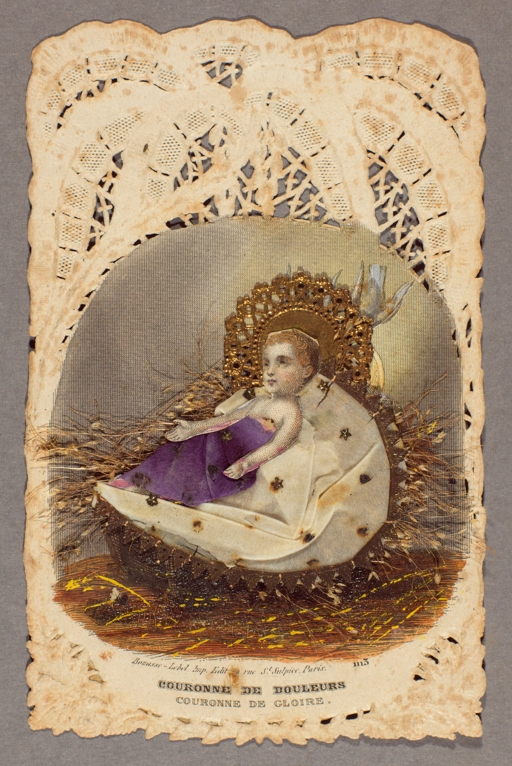 A devotional card made in Paris in the mid-1800s that reads, “Crown of sorrows, crown of glory.” The image is engraved on lace paper, with applied elements including die-cut and gilded scraps, tissue and dried flowers.
