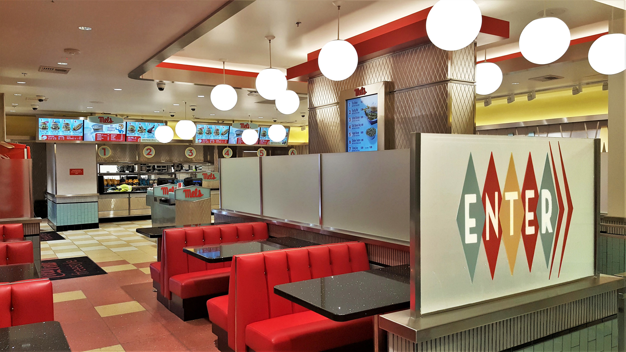 Mels diner. 6o's asthetic with red booths and spherical pendant lights