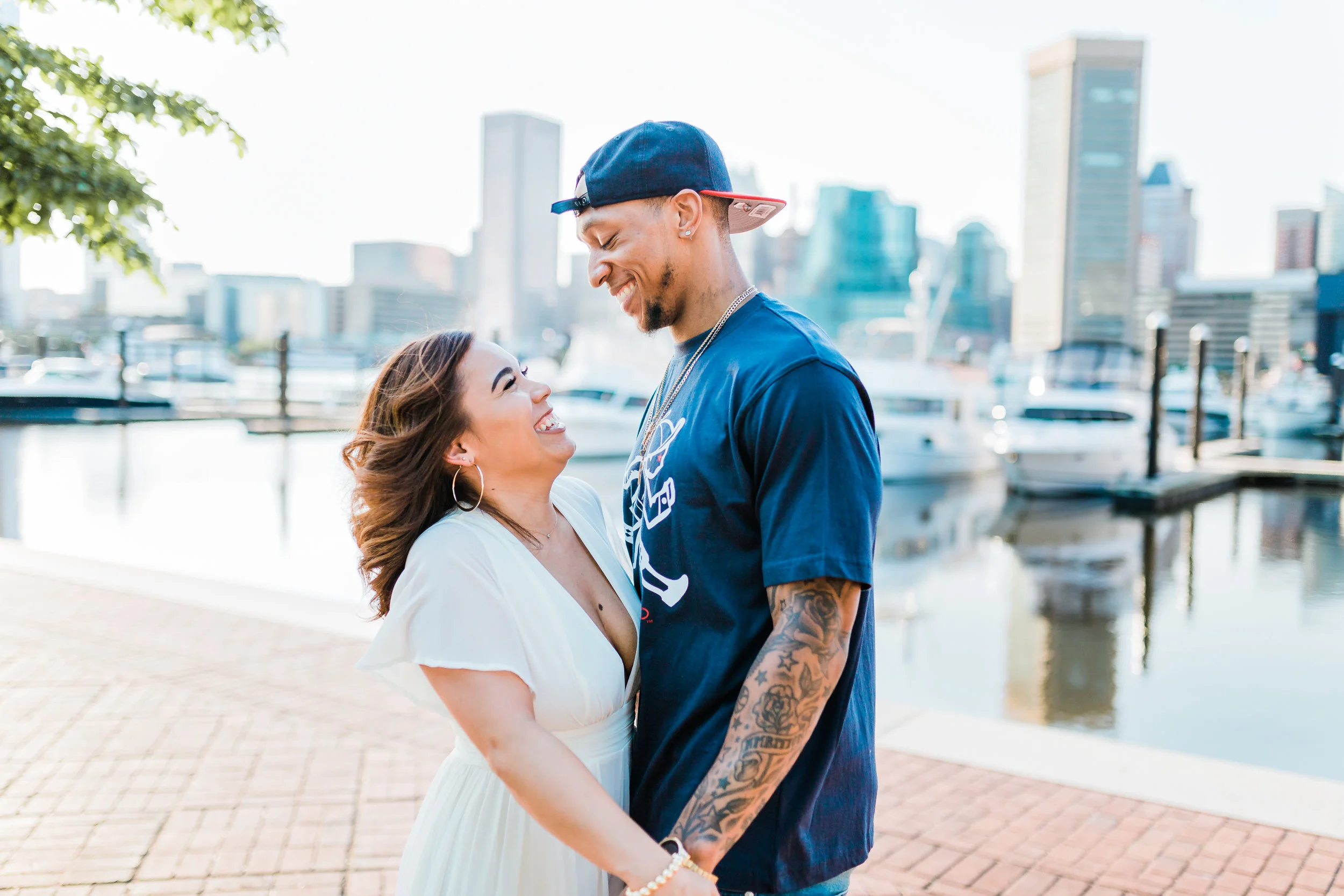 couple laughing together during their engagement session in downtown baltimore