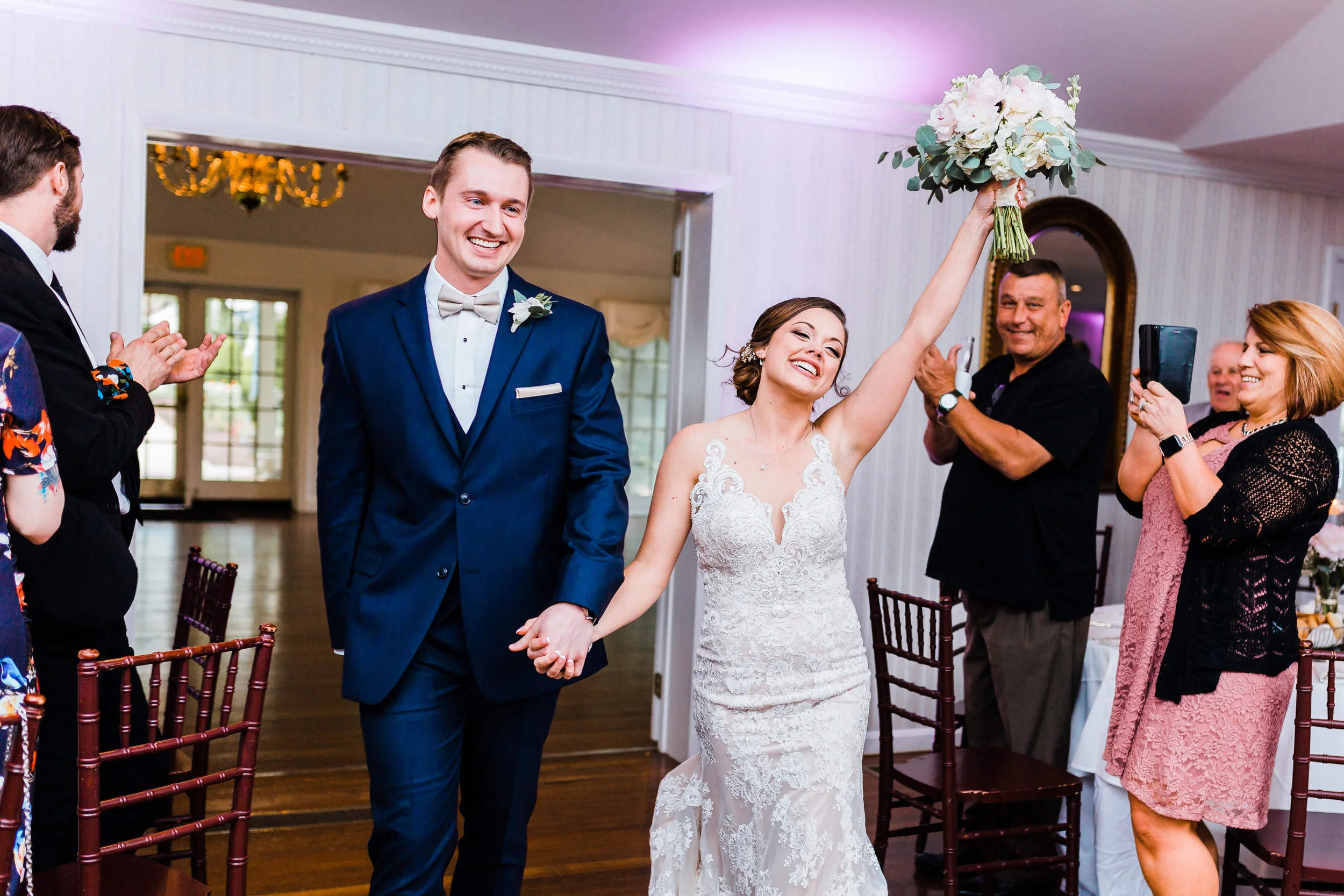 bride and groom coming in to their reception maryland wedding photographer