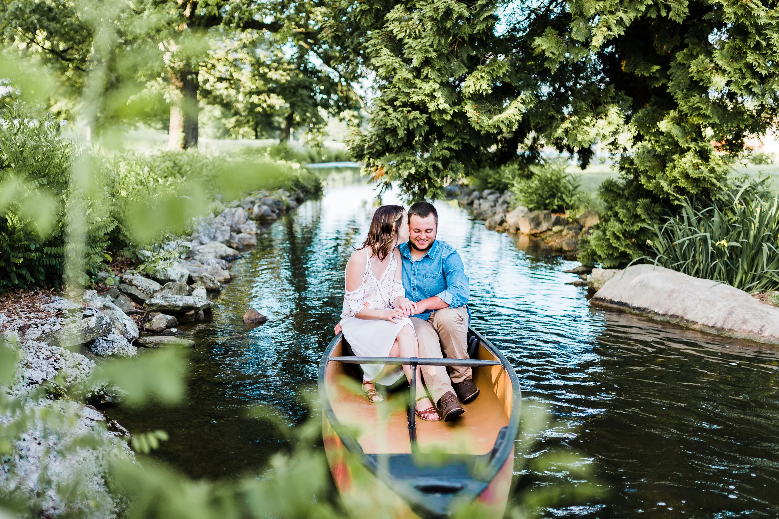 couple snuggling in a canoe at md engagement session