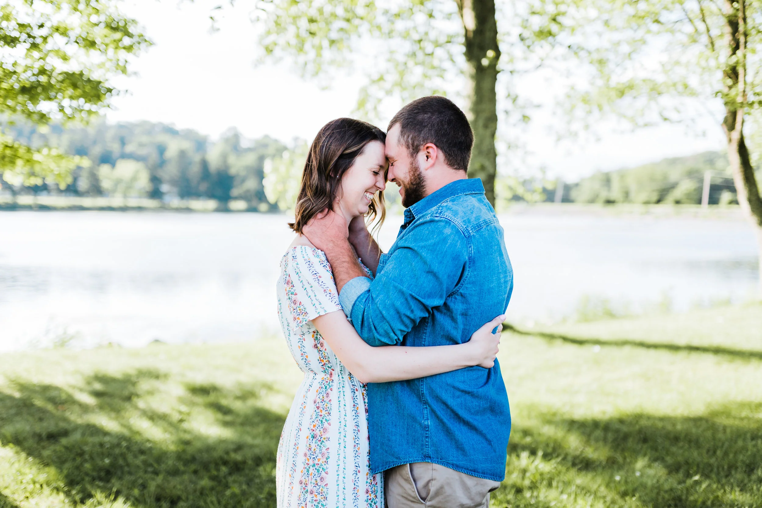 groom romantically holding his bride while they giggle at md engagement photo session
