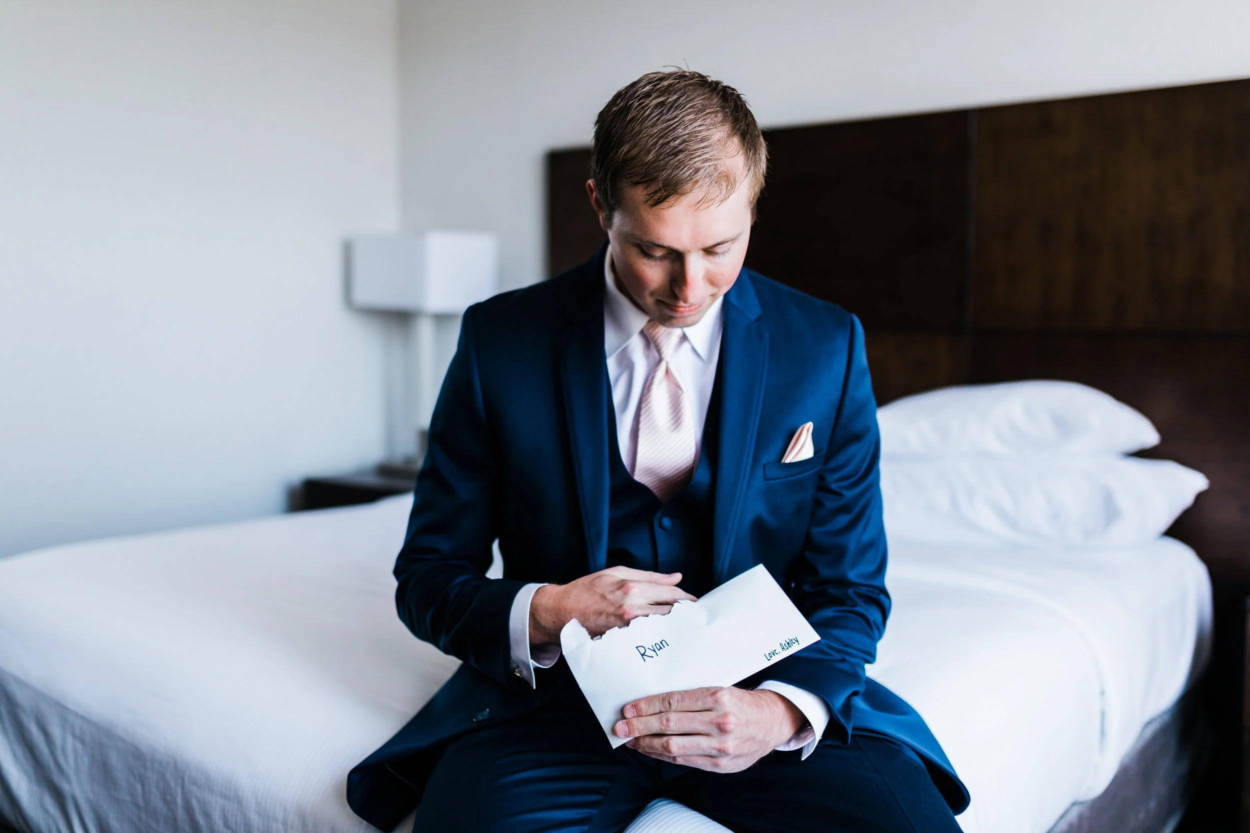 groom reading his letter from his bride - celebrations at the bay maryland wedding photographer