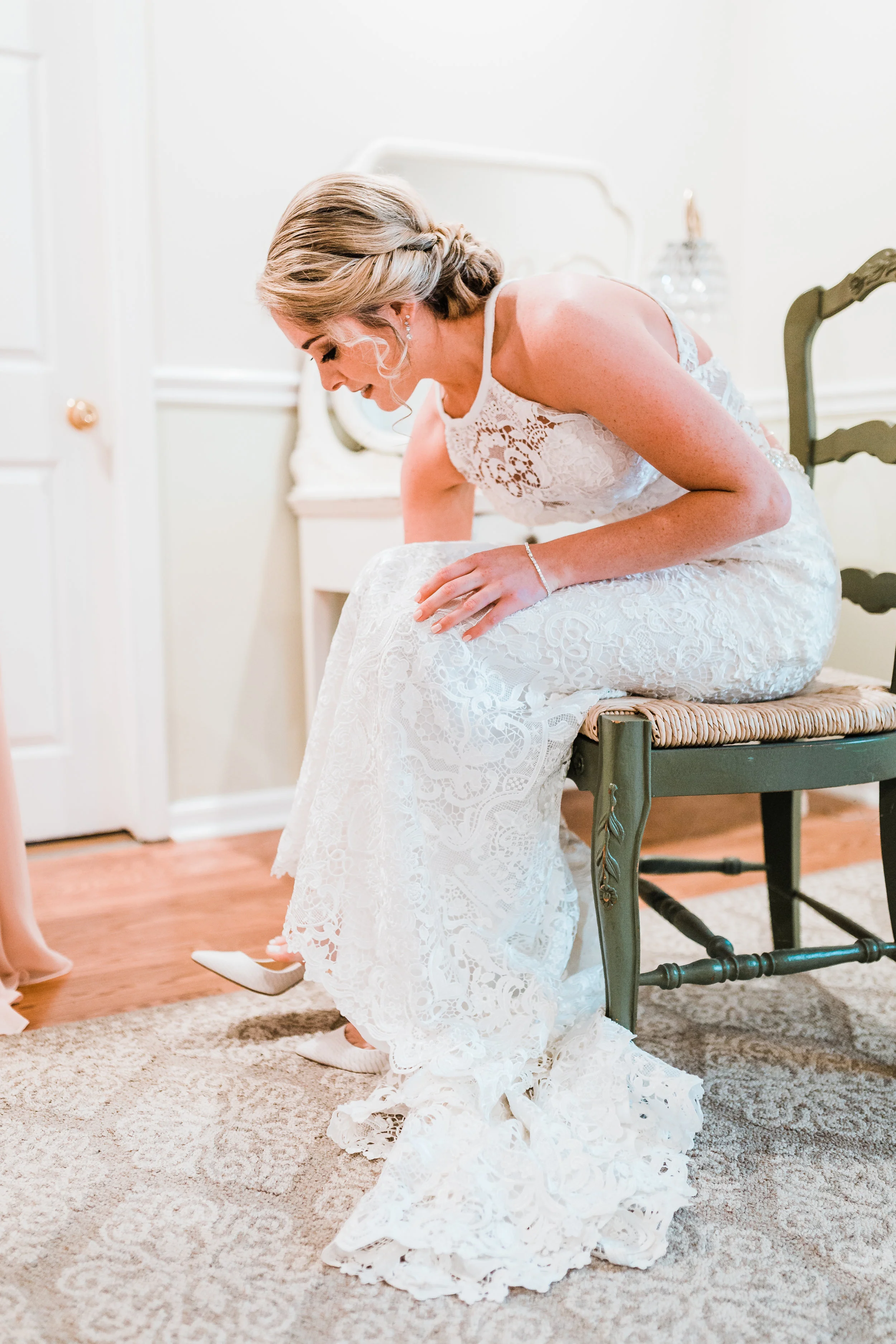 bride putting her shoes on at celebrations at the bay - maryland wedding photographer
