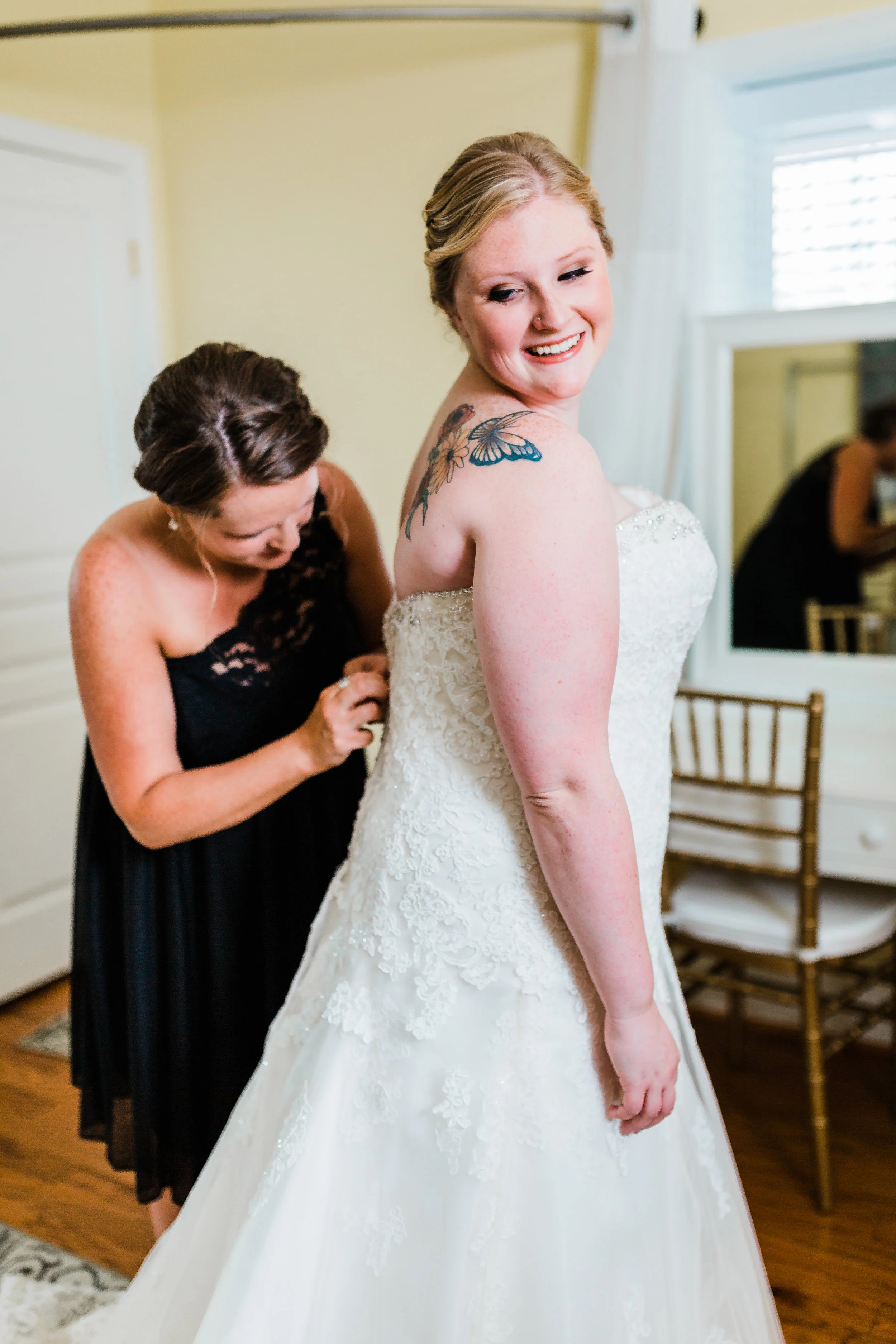 bride with her matron of honor getting her dress on - kurtz's beach wedding - maryland wedding photographer