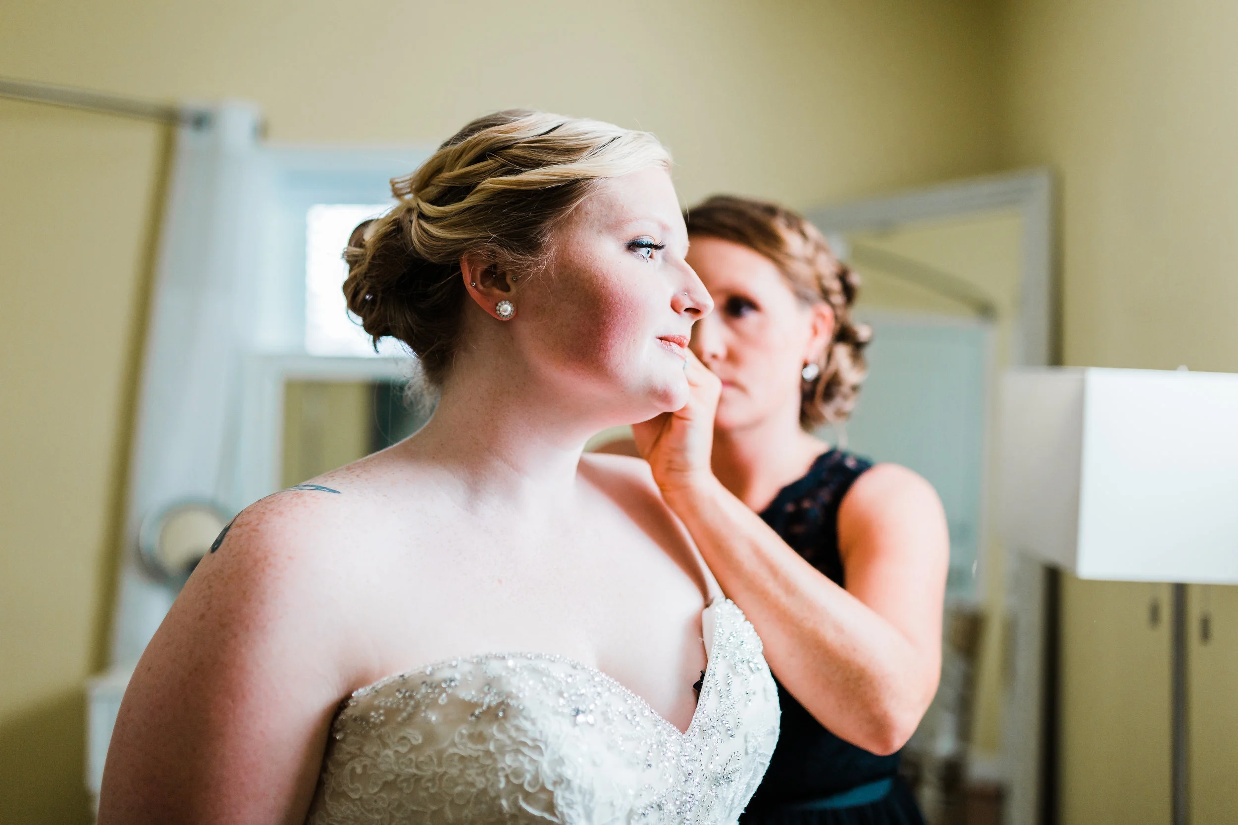bride putting her earrings on in pasadena md - kurtz's beach weddings - best md wedding photo and video