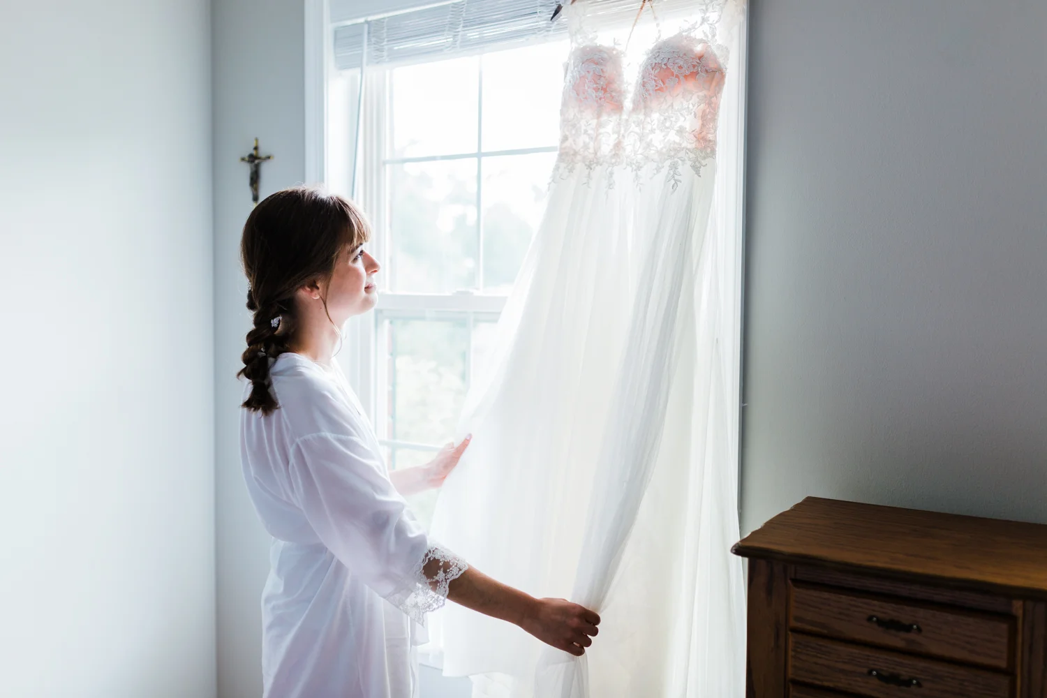 bride admiring her wedding dress - md wedding photo and video