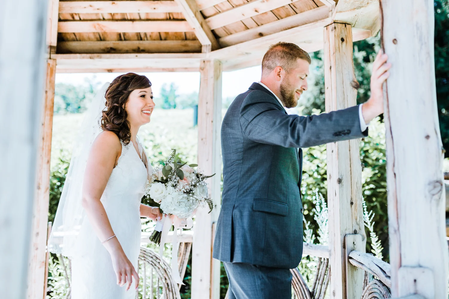 bride about to tap grooms shoulder for first look - Liberty Mountain Resort
