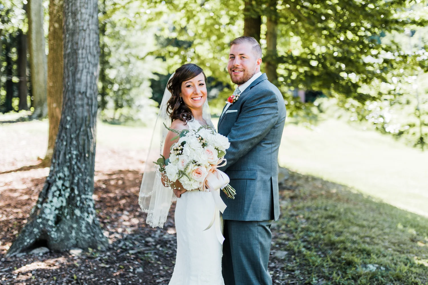 Tarah and Eric smiling together in the woods at Liberty Mountain Resort - PA wedding venues - best MD wedding photographer and videographer